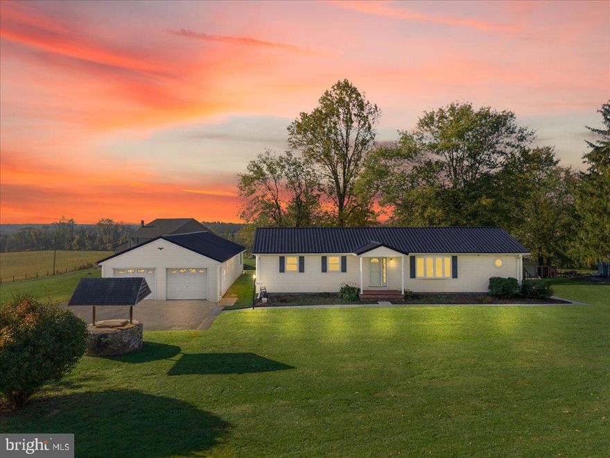 Located on nearly 2 acres with scenic views in the distance, your country retreat awaits! You will love this 3 bedroom, 2 bath rancher with new metal roof.  Entering the front door, you will appreciate the living room which offers plenty of natural light and hardwood floors.  There is a bonus room off the living room which could serve as an office, playroom, etc. Entering the kitchen, you will notice the mud room off the side which leads to one of the two rear decks.  Off the opposite end of kitchen, you will enter into the separate, formal dining room which offers hardwood floors. You will love the primary bedroom which also features an updated primary bathroom. The second and third bedrooms are also located on the main level.  The detached 3 car garage is heated and has both front and rear entry garage doors: perfect for the car enthusiast, workshop, and potential for a home office/studio. Don't wait, schedule your showing today!