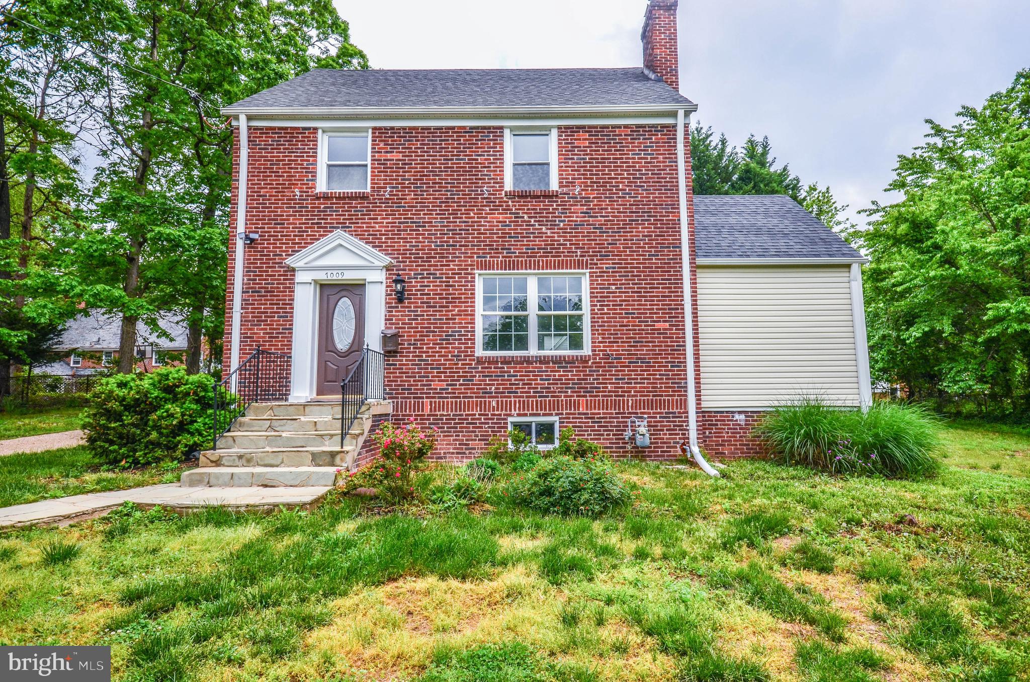 This beautifully renovated 4-level brick colonial is a must-see! The main level features a sunny living room with electric fireplace and an updated kitchen with quartz countertops, slow-close cabinetry, and stainless steel appliances, all open to a spacious dining room. Off the dining room, you'll find a versatile bonus room or office. The upper level includes a landing with a cozy sitting area, a master bedroom with a private bath, and a sizable second bedroom. The top level boasts a finished attic, perfect for a 4th bedroom. The fully finished basement offers even more living space, including a den, a 4th bedroom, a wet bar, and an updated full bathroom with a tile shower. This home sits on a large lot, conveniently located near the University of Maryland, major commuter routes, and public transportation. The driveway and rear parking pad provide off-street parking for multiple vehicles.