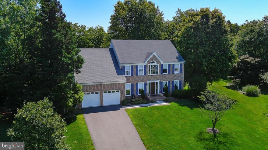 Elegant but casual interior, lots of natural light,  spacious rooms,  many beautiful updates, a screened porch, 2 stone fireplaces, and a delightful and expansive rear yard (3/4 acre) all help make this a welcoming home, practically pleasing and aesthetically satisfying!  Upgraded bluestone walkway, brick stoop, and new front door all enhance the home's curb appeal. The two-story foyer features a winding staircase and palladium window.  The main level library boasts wall-to-wall bookshelves and can be closed off from the entry with French doors,  providing the ideal home office. A powder room is off the hallway.   The gourmet kitchen features a new gas cook-top, stainless appliances, large center island and ample counter space ( granite).  You'll love the large window overlooking the herb garden.  Enjoy meals and gatherings in the  breakfast area (with built-in bookcase)  --this opens to the large family room with stone fireplace flanked by windows, and to the charming screened porch. A mudroom between the kitchen and garage offers cabinetry and a desk area.  The garage has just been fully painted - walls, ceiling and flooring.    ***  Upper level primary suite consists of the  bedroom, spacious sitting room, and luxuriously renovated bath with waterfall shower, free-standing tub, heated flooring, and beautiful vanity area. Closet is a full walk-in.  Three other bedrooms and a beautiful, modern  hall bath complete this level. 
Lower level  offers a cozy gathering place with a stone fireplace and wet bar,  a bonus /exercise room,  a large den or guest room. and huge storage area which is under the family room.  New ceramic tile flooring adds great appeal and function!  Walk-up stairwell exits to the side.  Roof is about 10 years old, HVAC 4-5. Brand new cooktop.  Irrigation system in place.  Second refrig, separate freezer will convey.  Trampoline can convey.  Quick settlement, then 60 day rent-back preferred.