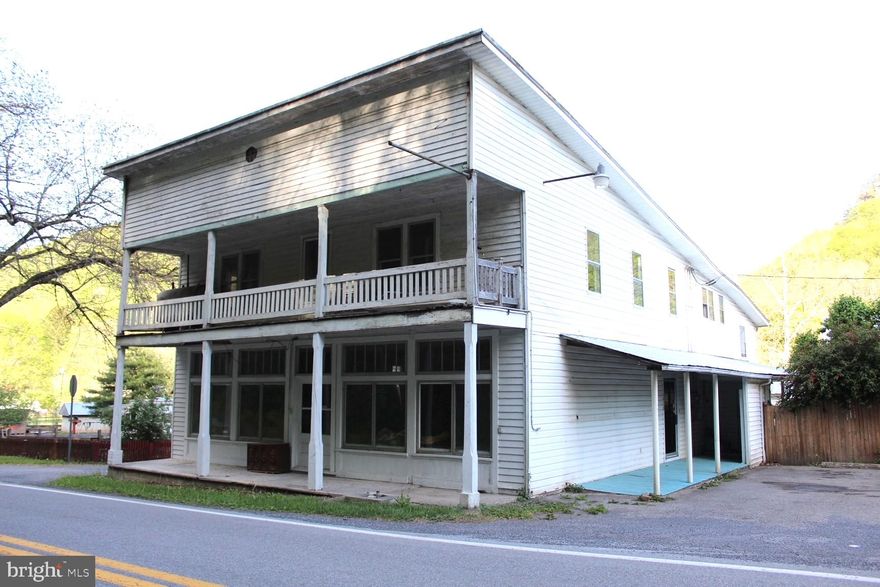 Great Investment Opportunity! Featuring a store front, 2 apartments, large storage area and a small yard in the middle of the quaint Town of Riverton.  This property has lots of potential for anyone looking for starting your own business and living in the same.  Featuring 2 apartments: ground level apartment has 3 bedrooms with a full bath and a small, fenced in backyard; upstairs apartment has 1 bedroom, full bath, laundry room and 3 extra rooms.  There is a large room on the back of the building that would be perfect for storage.  The front is a large, open room with original hardwood floors, perfect for a store front; total building is 5,616 square feet.  Good bones, needs some TLC.