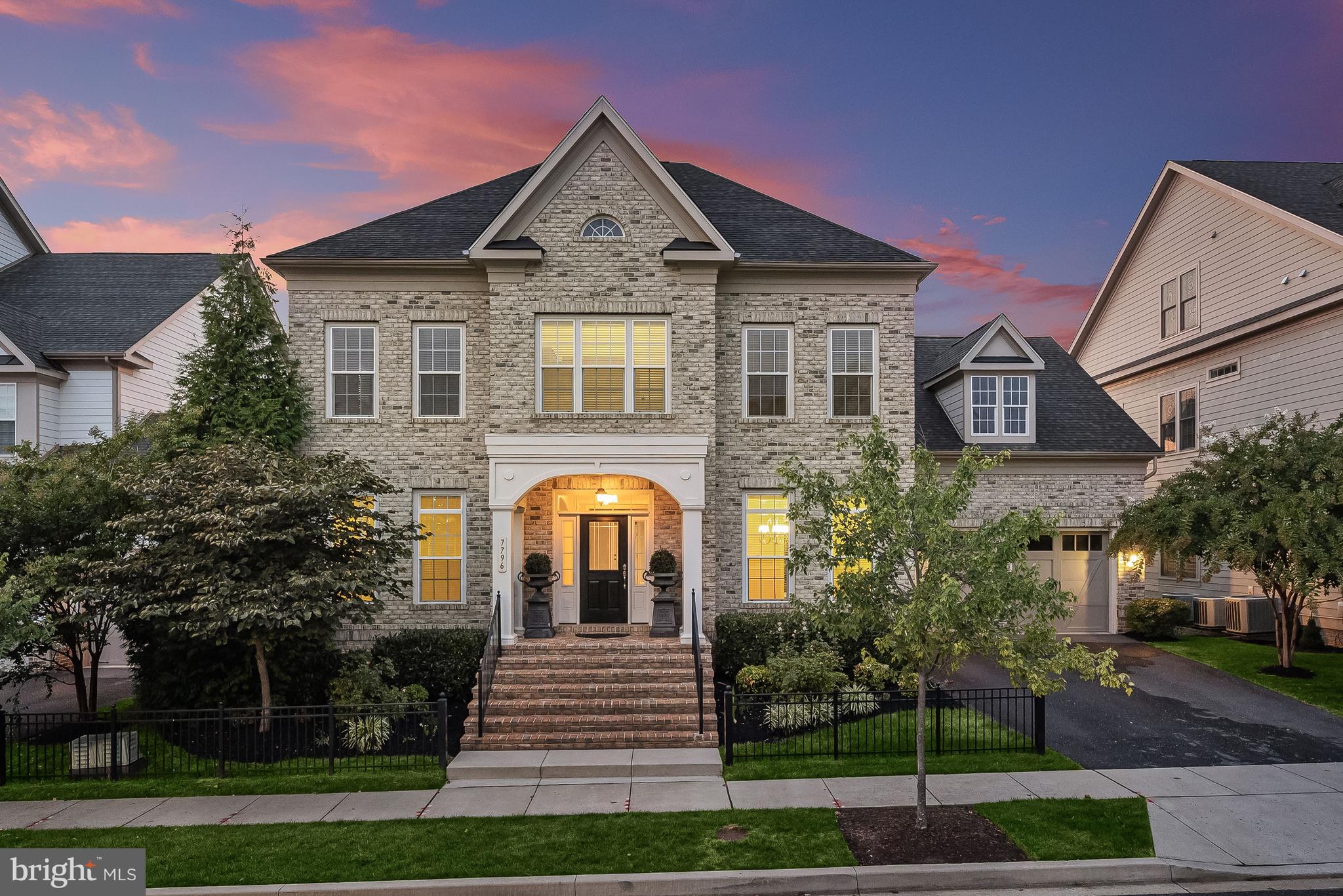 Stunning Williamsburg Homes brick front Brightwood Model sited on a premier lot in Howard County’s highly desirable Maple Lawn community with over 5,000 sq. ft. of luxurious living space highlighting 9 ft. + ceilings, grand arched doorways, new carpet and fresh paint throughout.. Enter the sun filled foyer to living and dining rooms showcasing accent molding and beautiful hardwood flooring, creating the perfect ambiance for intimate gatherings. Ideal for entertaining, this bright and airy open floor plan includes a family room with built-in bookcases and a gas burning fireplace, and a gourmet kitchen with a breakfast nook, an entertainer’s island under stylish pendant lights, granite countertops, 42 in. white cabinetry, a butler’s pantry, and offers access to the deck. Off the kitchen, there’s a spacious mud room with built-in storage that leads to an oversized pantry. Ascend the staircase to the owner’s bedroom suite under an impressive tray ceiling with a walk-in closet and en suite luxury bath with a soaking tub, dual granite vanity and oversized shower with seating and decorative tile inlay. Another sizable bedroom has its own full en suite bath, two additional bedrooms, a hall bath, and a laundry room complete the upper level. Plenty of room to roam in the walkout lower level that provides a recreation room with walkout access to the backyard, a fifth bedroom or flex room, a full bath, and abundant storage space. Enjoy outdoor living on the expansive Trex deck and landscaped backyard, backing to trees, and all of the vast amenities this community offers such as a swimming pool, clubhouse, sports courts, tot lots, and more, with nearby shopping, dining, and entertainment options.
