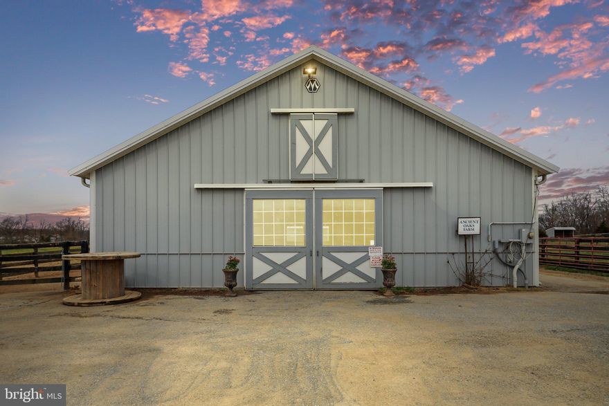 IMPROVED PRICE!!! This is your opportunity to walk in with equity! TURNKEY HORSE FARM WITH INCOME OPPORTUNITIES! If you're an equestrian or have a passion for horses, then welcome home to 28+ acres of peace and beauty in Jefferson County, WV! A rare opportunity to own a one of a kind, well-equipped and impressive horse farm with no restrictions, gorgeous views and privacy. This unique property offers versatility and opportunities! Enjoy the ease of boarding and riding your own horses or create an equestrian facility or horse farm.  The farm boasts an outdoor arena with footing of 4" stone base 3" tidings sand that is 200x100, an indoor arena with 4" stone base, 3" of rubber sand mixture with temperature controlling beads and LED lighting inside and out, it is 66x130, with 10' of viewing area, 8 fenced paddocks with electrical fencing to divide, a 10 stall barn with 12x12 matted stalls, hot and cold wash bay, handicap accessible bathroom, a separate block barn previously used as a stud and foaling barn, now with a stall and run in shed that includes overhead hayloft, 5 additional stone dust run-in sheds, 1 extra large round pen with sand, two grass round pens (one extra tall and one moveable), a new permanent second septic at barn, and 2 automatic waters. The contemporary cedar home, with 3 primary suites, sits perched overlooking gorgeous pastures. The main level features an inviting family room with pellet insert, a spacious kitchen with island and double ovens, dining room and main level primary suite with a newly renovated bathroom! The upper level provides 2 spacious bedrooms, each with en suites. The unfinished basement offers plenty of additional storage space and opportunities. Additional features include a 60x40 detached garage/workshop, new HVAC, new washer/dryer, new 80 gallon plastic hot water tank, new water softener, new blue light filtration system, new underground water drain off system surrounding the house, new PVC piping, new roof, new decks, hardwood floors, gorgeous landscaping, RV pad/water/electrical hook up behind indoor arena and a circular driveway. Don't wait to schedule your private showing! Motivated sellers, bring all offers!