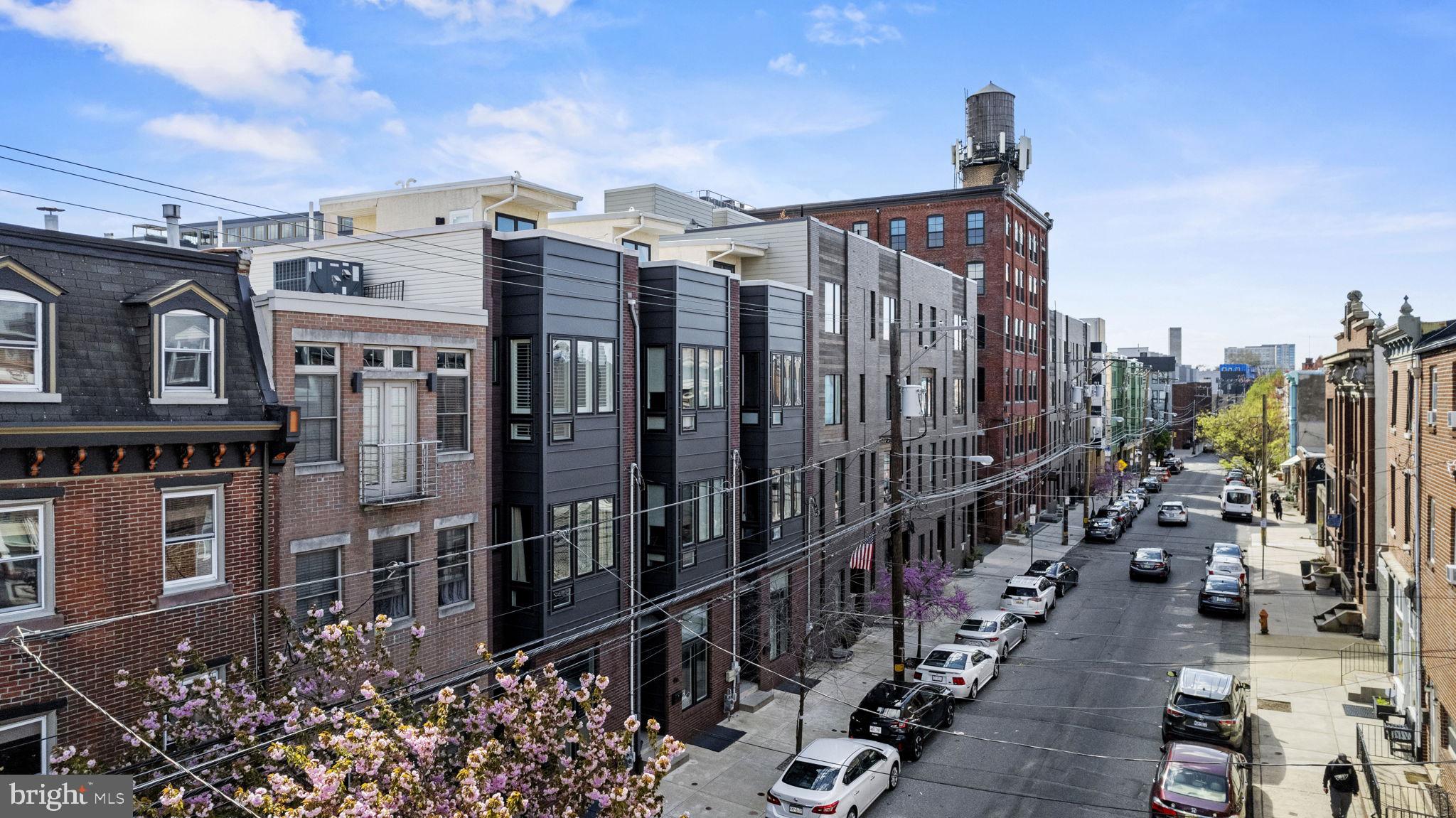 Welcome to 418 Fairmount Avenue, a stunning newer-construction home in the heart of Northern Liberties—one of Philadelphia’s most dynamic and sought-after neighborhoods.
With over 2,700 square feet of beautifully designed living space, this 4-bedroom, 3 full and 2 half-bath residence offers the perfect blend of style, functionality, and urban convenience. Enjoy the rare bonus of deeded parking and three private outdoor spaces, including a ground-level fully fenced patio and a spacious roof deck with panoramic views of the Ben Franklin Bridge and Philadelphia skyline.
Inside, you’ll find wide-plank hardwood floors, soaring ceilings, and recessed lighting throughout, creating a bright and airy feel. The main living space is anchored by a show-stopping chef’s kitchen with sleek modern cabinetry, stainless steel appliances—including a 6-burner gas range—an oversized center island, and a stainless steel inset sink framed by windows that let in abundant natural light. The kitchen flows seamlessly into a large dining area, with sliding doors that lead to a second outdoor space, perfect for al fresco dining or a morning coffee.
Upstairs, two spacious bedrooms each feature hardwood flooring, generous closet space, and their own private en-suite bathrooms. The primary suite spans the entire top floor, offering a true retreat with a large walk-in closet and a luxurious bath complete with double vanities, modern tilework, and an oversized glass-enclosed shower.
Head up to the expansive roof deck, where you can entertain or unwind with one of the most iconic views in the city.
Located steps from local favorites like Café La Maude, North Bowl, Yards Brewing, Liberty Lands Park, and just minutes from I-95, I-676, and SEPTA, this home combines neighborhood charm with unbeatable access to the rest of the city.
With a low HOA fee and thoughtful modern design throughout, 418 Fairmount Avenue is more than just a home—it’s a lifestyle. Schedule your private tour today