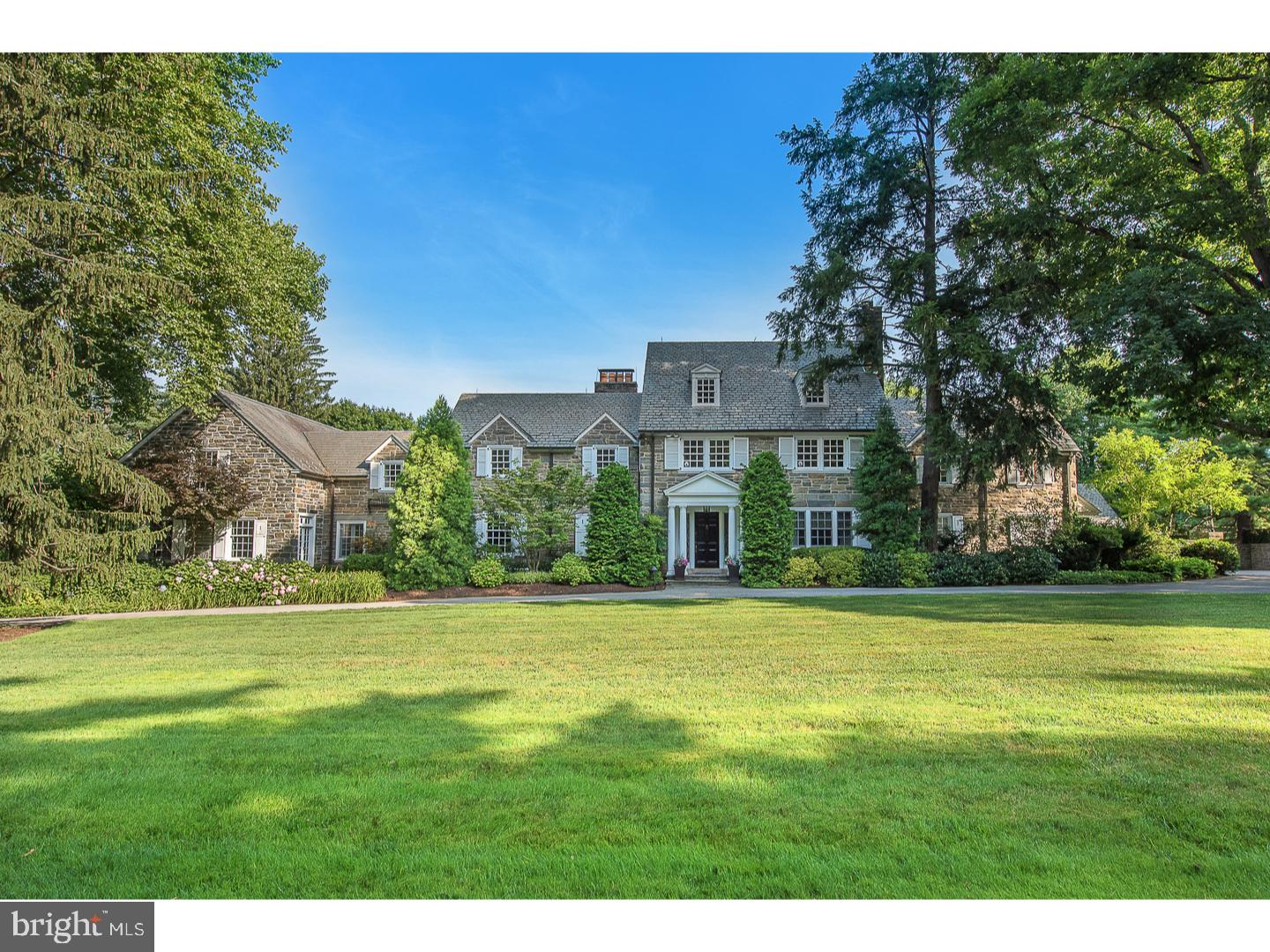 Here's your opportunity to live on the Main Line's most beautiful street. The expansive two plus acres totally private and all useable is unmatched . A wide circular driveway leads you to this majestic, all-stone timeless home. The first floor has a gorgeous New Kitchen recently enlarged with white custom cabinetry and striking marble counters. The kitchen has an oversized center island with seating and under-counter cabinetry. There are two sinks and dishwashers as well as a separate butler pantry with loads of extra cabinetry and counters to accommodate small appliances. The kitchen opens to the breakfast room and family room. The views from the kitchen, breakfast, and family room are filled with light, offering a striking view of the property that includes the swimming pool and entry to the slate patio. The breakfast and family rooms have high ceiling and a fireplace in the family room. The large center hall opens to a step-down living room with a high ceiling and fireplace offering symmetry to the room. The generous dining room has a third fireplace and double French Door entry from the center hall. The paneled study has a forth fireplace with an exit to the rear grounds. Two powder rooms are conveniently located on the first floor. Finally, there is a first-floor addition a bonus room whose use is limited only by your imagination. The addition ...stone and slate exterior was meticulously constructed to match the original structure. The addition has a large open room with a soaring ceiling. There is direct access to the pool and grounds from the addition. On the second floor you'll find the Master Suite with New his-and-her separate baths and separate dressing rooms. The New baths offer tasteful marble finishes for today's discriminating buyer. Also, there is an en-suite bedroom along with third and fourth bedrooms and hall bath. A separate staircase leads to an au pair suite or guess quarters with a mini kitchen. The laundry room is on the second floor. The third floor has two large bedrooms and a full bath. The exterior is everything you'd want...beautifully landscaped and plush grounds is the backdrop of a magnificent structure. There is a breathtaking pool with jacuzzi waterfall with Egyptian marble decking and tile that glistens like glass. The outdoor kitchen includes granite counters and a stainless-steel full size refrigerator, ice maker, gorgeous cabinetry and large stainless sink. There is a stainless built-in barbecue grille and storage drawers. The kitchen is inclosed by attractive sliding glass doors. For relaxing by the pool enjoy the outdoor gas fire pit next to the pool and kitchen.Also featured is a dressing room with cubbies, a full bath, a private outdoor shower, and large storage room for outdoor furniture. The pool equipment is hidden by a stone wall built to match the home. The four-car garage is walled off by a timeless elegant stone wall that provides complete privacy. If you are looking for a classic, elegant Main Line residence on the area s most desirable street, you have found your dream. ***This home has just undergone renovations offering a New Custom Kitchen and Master Baths....His and Hers!