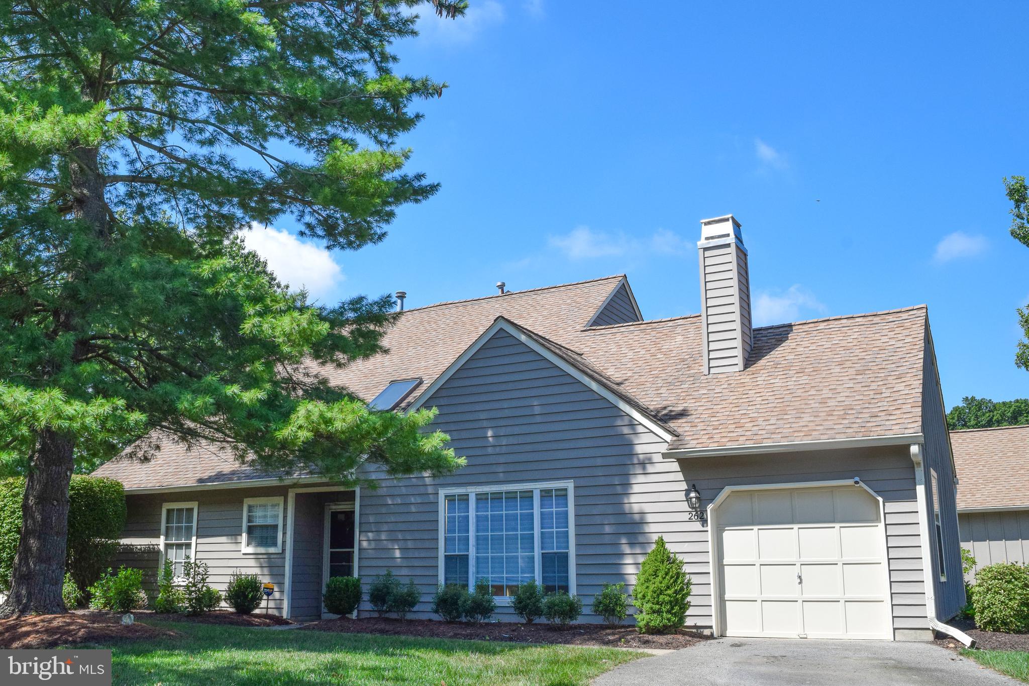 Welcome to this charming home located at 262 Copper Beech Drive in the desirable community of Blue Bell Woods. This residence offers a great layout with 2 bedrooms and 2.5 bathrooms, perfect for comfortable living. As you step inside, you'll notice the main level features luxury vinyl plank flooring throughout, providing a durable and stylish foundation. The living room is a focal point with its high cathedral ceiling, creating a bright and open atmosphere. The eat-in kitchen is a functional space for daily meals. This home offers a convenient first-floor primary suite, complete with a sitting area that has sliding doors leading to the back patio. The primary bathroom features a soaking tub and a separate stand-alone shower. This floor also includes a powder room for guests. Upstairs, a large loft overlooks the living room, a flexible area that can serve as a home office, a den, or even a potential third bedroom. There is also a bedroom and full bathroom on the second floor. Additional features include a one-car garage. This property is a wonderful opportunity to own a home in a great location, with a practical and versatile floor plan. 1-yr Warranty included with acceptable offer.
