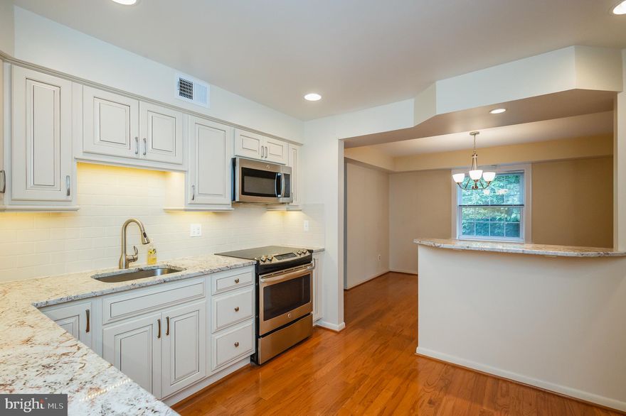 Completely update with practically new kitchen and both baths.  Kitchen features all stainless steel appliances, neutral cabinets with mocha glaze, built-in pantry, granite counters, under cabinet lighting, hardwood floor.  Spacious living room and dining room with hardwood floors & balcony overlooking trees. Hall bath with ceramic floor and tub surround, contemporary vanity & brushed nickel faucets.  Primary suite with almost new carpet, walk-in closet and updated bath featuring double vanity with one-piece top, ceramic floor and ceramic tile shower stall.    All this in the Mays Chapel subdivision with easy access to I-83, shopping and more!