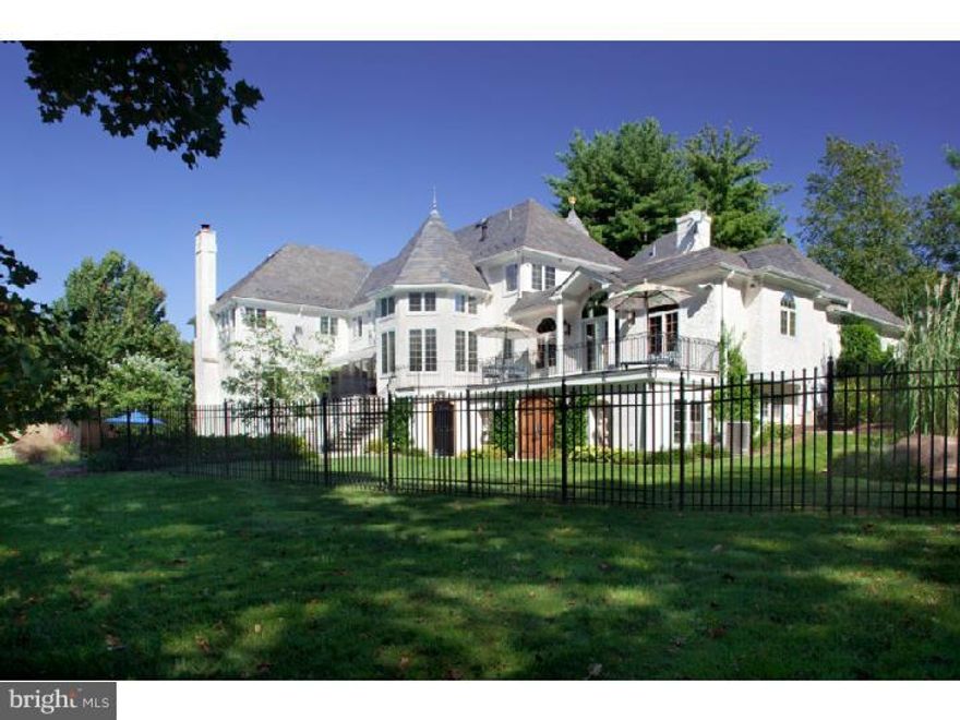 Benefiting from its end of cul de sac location this 5 bedroom French mansion styled home enjoys gated privacy & uninterrupted views of the property's manicured and conserved 2.11 acres. Carved richly stained  double doors lead to a 2 story marble Foyer with dramatic  sweeping staircase. To the right of Foyer find Library/ Music room paneled in handsome cherry wood with arched custom display and storage cabinetry, marble topped wet bar and gas burning f/p. Flowing from both the music room as well as the main foyer, is a step down formal L/R.  Detailed with a multi-piece coffered ceiling, centrally positioned gas burning f/p & 3 exposures of light, this room welcomes both small and large scale entertaining with similar ease and elegance. Formal D/R enjoys a corner placed gas f/p, service entrance to the gourmet Kitchen & pocket doors which provide access to a back Hall ideal for seamless entertaining and as a point of egress to the inviting 2nd level Terrace. Chefs Kitchen offers large granite seated and prep island, double oven, gas cook top and double sided fireplace which adds warmth and appeal to both the kitchen as well as the connecting two story Breakfast Rm. Conservatory styled windows offer views of the terraces and pool below, while steps away and through a well-appointed Home Office find a magnificent Moroccan inspired  F/R. Added to the home in 2006 this magnificent space offers well designed informal living & quality appointments including mosaic topped bar with leather and nail head trim, ornate tiled f/p and trey ceiling with inset detail. Ascend  stairs to the second level.  The Master Suite offers sitting area in front of the f/p, trey ceiling with Gracie inset panels, generous his and her outfitted walk in closets as well and  Master Bath.  A spectacular turreted office constructed of cherry wood provides ideal work or end of day space for returning a private call, 3 other Bedrooms, one with ensuite bath and the others with Jack and Jill Bath as well as a full Laundry Room complete this level.  Descend one of  the three staircases to find the Garden Level Arcade highlighted by a mosaic inlay in the ceramic tile floor.  With corner fireplace and the best of many views of the pool, this entertaining area is steps away from the cabana which features a Bath and Bar area. Rose gardens & additional landscaped rear grounds provide backdrop for Patio and spectacular pool w/free form Spa.