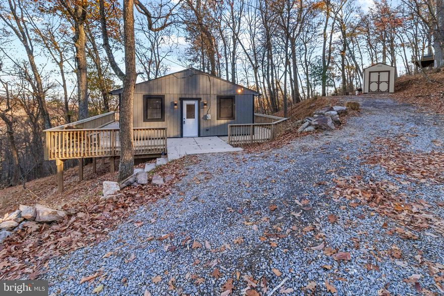 Wow! Peace and Tranquility at its best! Come and enjoy the gorgeous views and seclusion of this wonderful lake community. This home has been completely redone from top to bottom with a brand new metal roof and gutters, new plumbing and electrical , central air, new kitchen, bath and new floors and paint.  The main level consists of 2 bedrooms and 1 bathroom with a open floor plan living room/kitchen. Off the living room step onto your wrap around deck where you can enjoy the scenic views this property has to offer from every angle. The unfinished basement allows for additional living space or that game room you need.