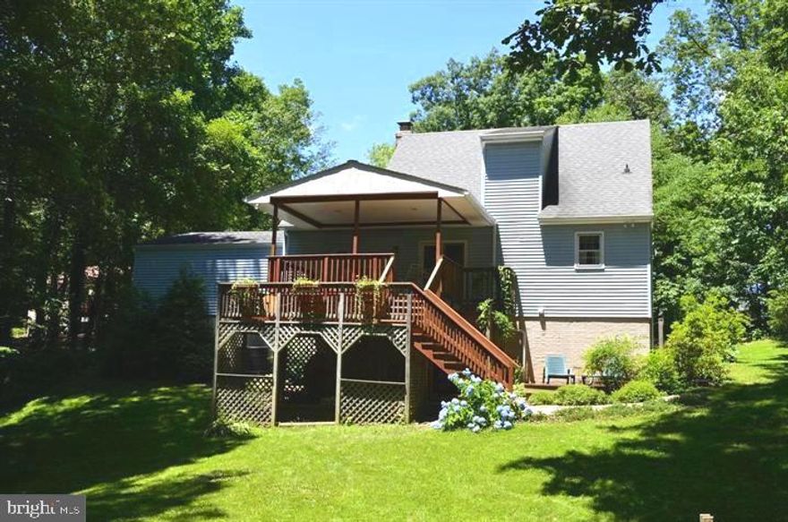 A TRUE COUNTRY HOME IN A BEAUTIFUL SETTING!! If you have been looking for that private country home, surrounded by woods, farmland, and just pure nature, this is it! Welcome home to this fabulous Cape Cod-style home down a long driveway off of a cul-de-sac.  Boasting an open floor plan, 3 bedrooms, and 2 full baths, you walk inside to the hardwood floors and brick fireplace (with pellet stove insert) in the living room.  The dining room/kitchen combo boasts a slider out to the covered back deck.  The large primary bedroom on the main floor has wainscoting and a walk-in closet. The full bath on the main level has already been updated for you! Upstairs you will find 2 large bedrooms served by a fully updated bathroom! The basement features a large gathering area for the family, along with a bonus room (with closets)  that could be used for anything you can imagine.  But THE JEWEL of this home is the 3-level covered back deck! Walk outside to listen to the birds sing and watch nature go by. The top level is accessed by a slider in the kitchen and the bottom is accessed by the walk-out basement.  Recently stained, this deck is surrounded by woods! Sit in the cool breezes and watch the deer, fox, and other critters go by as you enjoy morning coffee or your after-work beverage. An amazing slice of nature that is all yours!! The house also has a 2 car garage, shed, chicken coop, trampoline, and ninja warrior set-up in the backyard! The kids will be in heaven also! Recent upgrades include new energy-efficient windows about 5 years ago, a recently opened up kitchen, and a new HVAC in 2021,.  This picturesque slice of country living is a must-see!! All offers due Monday 6/26, at 5 PM.