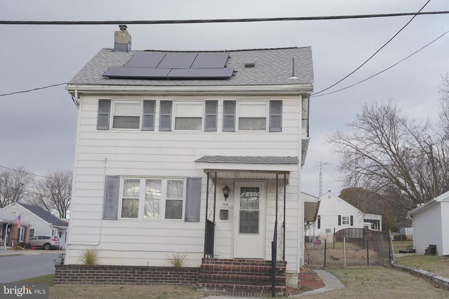 This 3-bedroom, 2-bath Colonial-style home sits on a spacious corner lot within the City of Martinsburg and offers a blend of classic character and everyday functionality. Built in 1920, the home features 1,856 finished square feet with a large family room, separate living and dining areas, and an eat-in kitchen. All three bedrooms and a full bath are located on the upper level, along with a bonus room that provides flexible space for an office, sitting area, or storage. The main level includes a full bath and convenient laundry area with washer and dryer. Exterior highlights include a recently replaced roof with solar panels that convey to the new owner, a welcoming porch, and an oversized two-car garage with inside access, additional storage, and off-street parking. The cleared, level yard offers side and front yard space.  Located close to local amenities with easy access to major routes.