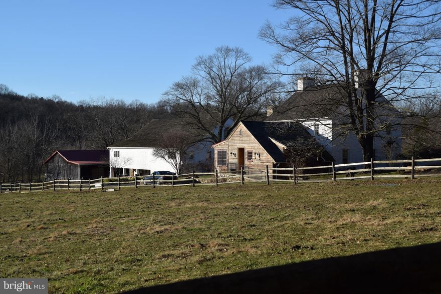 A Rare and Exquisite Farmstead on 160 Acres
Welcome to a once-in-a-lifetime opportunity to own approximately 160 acres of pristine countryside featuring a meticulously maintained 1800s stone farmhouse, expanded with a luxurious first-floor primary suite addition in 2013. The heart of the home is a stunning gourmet country kitchen equipped with a Viking gas stove, Miele dishwasher, and custom cabinetry. The second floor offers a spacious bedroom suite with bathroom, two additional bedrooms, and a full hall bathroom. Enjoy beautifully landscaped English-style gardens with a gas hookup for your BBQ, a greenhouse, and serene outdoor living. The home is outfitted with multiple HVAC systems and a backup generator for year-round comfort and peace of mind. The bank barn includes a game room with a kitchenette and powder room, plus a separate apartment featuring a kitchen, full bath, living area, and a loft bedroom—ideal for guests. The barn’s lower level offers garage space for up to four vehicles or farm equipment, as well as horse stalls. With panoramic views spanning three townships and two counties, this magical sanctuary is perfect for riding, relaxing by a the stream fishing, or simply enjoying the beauty of nature. Property is under Act 319/515 for preferential tax assessment. Total acreage includes two additional parcels. 2025 annual taxes reflect the combined total for all three parcels.  Showings by appointment only, 24 hours noticed required.