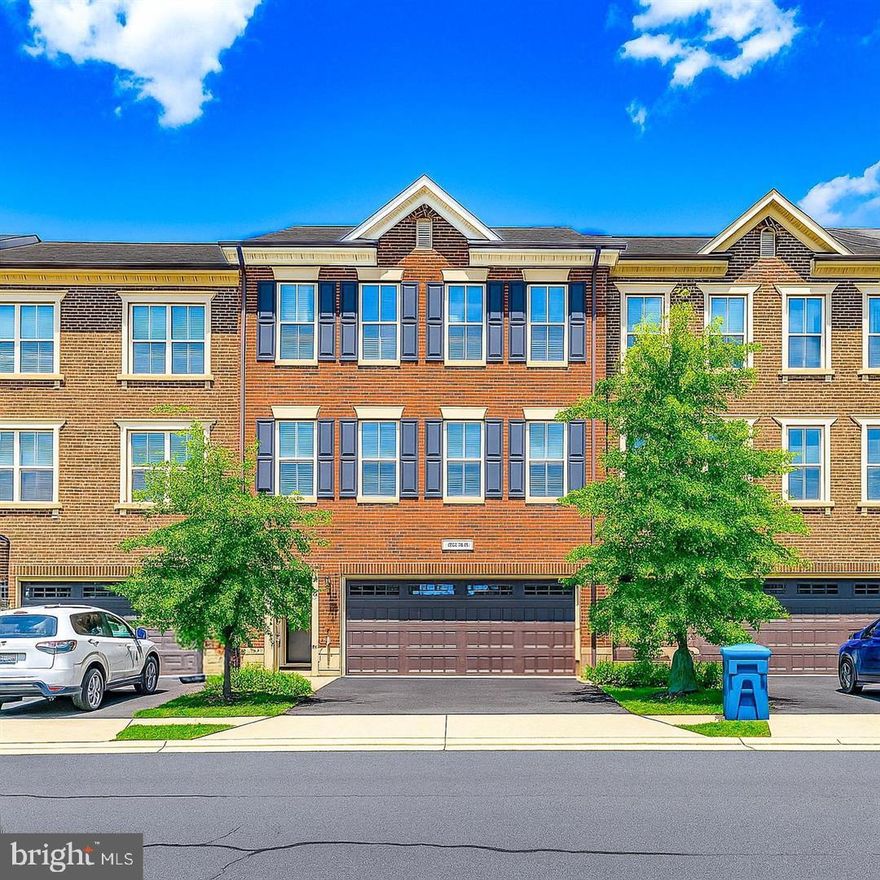 Elegant brickfront townhome located on the quiet outer edge of the sought-after Brambleton community, where HOA fees include cable and internet. This beautifully upgraded 3-level home offers 3,083 sq ft of finished living space with 3 bedrooms, 3.5 baths, and a 2-car garage.

The main level features rich hardwood floors, abundant natural light, and an open-concept layout. Formal living and dining areas flow seamlessly into a cozy office nook, while the spacious family room opens to a gourmet kitchen with center island, granite countertops, stainless steel built-in appliances, designer backsplash, and premium lighting. Sliding doors lead to a large deck, ideal for entertaining.

Upstairs, the luxurious owner’s suite includes a tray ceiling, sitting area, walk-in closets, and a spa-like bath with dual vanities, soaking tub, glass-enclosed shower, and oil-rubbed bronze fixtures. Two additional bedrooms, a full bath, and upper-level laundry complete the space.

The fully finished lower level offers a versatile rec room with hardwood floors, built-in shelving, fireplace, full bath, garage access, and sliding doors to a private fenced yard with paver patio.

Enjoy Brambleton’s top-rated schools, exceptional amenities, and convenient access to shopping, dining, and commuter routes. A rare opportunity to own an exceptional townhome in one of Loudoun County’s most desirable communities.