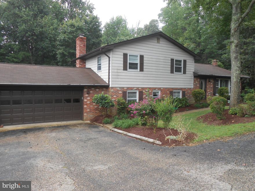 Neat and clean and ready for immediate move in.  Lots of room here. 4 level split level with hardwood floors, fireplace, deck, 2 car garage, separate living and family room. Circular paved driveway.