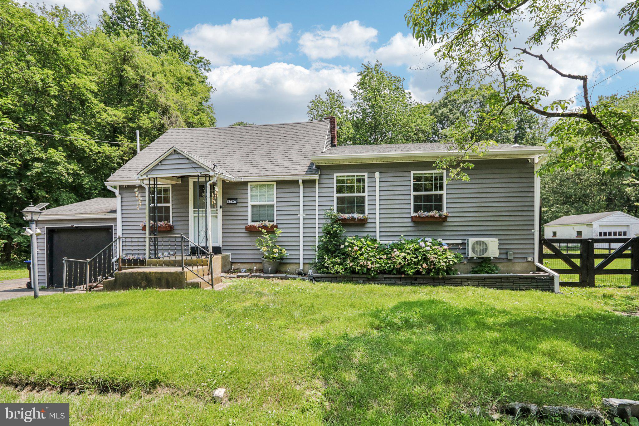 !! Showing for July will be available on the 13th-17th & 29th-31st !! Tucked away at the end of a peaceful dead-end street, this lovely and spacious Cape Cod home offers charm, privacy, and ultimate convenience—fully furnished and move-in ready! Enter through the front door into a cozy dining nook that opens seamlessly to the eat-in kitchen, featuring stainless steel appliances, ample counter space, and a breakfast bar with seating. The expansive living room boasts soaring vaulted ceilings, creating an airy and inviting space perfect for gathering with family and friends. Elegant glass French doors lead to a generously sized deck overlooking the huge, flat backyard—ideal for entertaining or relaxing outdoors. A laundry room just off the living space offers easy access to the side yard and driveway. Nicely tucked away on the main level is the primary suite, complete with a private ensuite bath featuring a glass-enclosed walk-in shower and walk-in closet. A second bedroom and a full bathroom with a tub/shower combo and linen closet provide comfortable accommodations for guests or family. Upstairs, discover a fun hidden gem: a third bedroom and half bath cleverly concealed behind a bookshelf-turned-hidden-door, complete with built-ins and tons of character. The full basement offers fantastic storage space. As a bonus, the vacant lot next door at 1709 Peach Street is included in the sale, giving you extra space or potential to expand. This home has been a popular short-term rental with all 5-star guest reviews, making it a great opportunity for investors or those looking for a personal getaway. With just a few exceptions, everything you see is included—just unpack and enjoy!