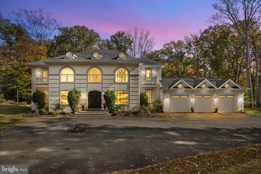 Welcome to 13025 Yates Ford Road — nestled on five acres, timeless craftsmanship meets modern luxury in the heart of Clifton. From the moment you step through the front doors, you'll feel the home's inviting elegance. The soaring two-story entryway, detailed wainscoting, and exquisite crown moldings set the tone for what lies ahead: a residence where architectural detail and comfort coexist in perfect harmony.

The great room, framed by a dramatic coffered ceiling and two stories of sun-drenched windows, flows seamlessly into the gourmet kitchen — the heart of the home. Here, exposed wooden beams add warmth and character above a well-sized island with breakfast bar seating, while the morning room invites you to linger over Sunday pancakes and waffles with sunlight streaming in.  The kitchen features a chef-inspired kitchen with a Wolf Sub-Zero appliance suite and a walk-in pantry for all the ingredients!

An upper-level loft overlooks the great room below, creating an open, connected feeling throughout the home. The main level also offers both formal and casual spaces — a dining room for special gatherings, a refined sitting room for quiet conversations, and two versatile flex rooms that adapt effortlessly as a main level bedroom or dual home offices. A full bath, powder room, and mudroom off the three-car garage complete the thoughtful main level design.

Upstairs, the primary suite is a sanctuary of sophistication. Through double doors, a tranquil sitting area and double-sided fireplace welcome you to unwind beneath tray ceilings. The spa-inspired ensuite features dual vanities, a newly added soaking tub, and an expansive walk-in shower — complemented by two generous walk-in closets. Three additional bedrooms each include their own private ensuite bath, with the added convenience of an upper-level laundry room.

The fully finished lower level is designed for both relaxation and entertainment — complete with a wet bar and wine fridge, spacious recreation area, fitness studio, a fifth bedroom, and a full bath. Step outside to your private backyard retreat featuring a built-in hot tub and fire pit — perfect for al fresco dining, evening stargazing, or cozy bonfires beneath the trees.

Set on a tranquil, tree-lined lot, this home offers luxury living that feels grounded, welcoming, and deeply personal. The Historic Town of Clifton exudes small-town charm reminiscent of a quaint countryside village, yet you're just moments from modern conveniences, scenic parks, and Paradise Springs Winery — and less than an hour from Washington, D.C.

13025 Yates Ford Road is more than a home — it's a place where every space tells a story, and where every day feels just a little bit extraordinary. Mortgage savings may be available for buyers of this listing.