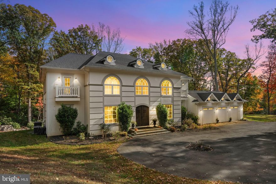 Welcome to 13025 Yates Ford Road — nestled on ten secluded acres spanning two parcels, timeless craftsmanship meets modern luxury in the heart of Clifton. From the moment you step through the front doors, you'll feel the home's inviting elegance. The soaring two-story entryway, detailed wainscoting, and exquisite crown moldings set the tone for what lies ahead: a residence where architectural detail and comfort coexist in perfect harmony.

The great room, framed by a dramatic coffered ceiling and two stories of sun-drenched windows, flows seamlessly into the gourmet kitchen — the heart of the home. Here, exposed wooden beams add warmth and character above a well-sized island with breakfast bar seating, while the morning room invites you to linger over Sunday pancakes and waffles with sunlight streaming in.  The kitchen features a chef-inspired kitchen with a Wolf Sub-Zero appliance suite and a walk-in pantry for all the ingredients!

An upper-level loft overlooks the great room below, creating an open, connected feeling throughout the home. The main level also offers both formal and casual spaces — a dining room for special gatherings, a refined sitting room for quiet conversations, and two versatile flex rooms that adapt effortlessly as a main level bedroom or dual home offices. A full bath, powder room, and mudroom off the three-car garage complete the thoughtful main level design.

Upstairs, the primary suite is a sanctuary of sophistication. Through double doors, a tranquil sitting area and double-sided fireplace welcome you to unwind beneath tray ceilings. The spa-inspired ensuite features dual vanities, a newly added soaking tub, and an expansive walk-in shower — complemented by two generous walk-in closets. Three additional bedrooms each include their own private ensuite bath, with the added convenience of an upper-level laundry room.

The fully finished lower level is designed for both relaxation and entertainment — complete with a wet bar and wine fridge, spacious recreation area, fitness studio, a fifth bedroom, and a full bath. Step outside to your private backyard retreat featuring a built-in hot tub and fire pit — perfect for al fresco dining, evening stargazing, or cozy bonfires beneath the trees.

Set on a tranquil, tree-lined lot, this home offers luxury living that feels grounded, welcoming, and deeply personal. The Historic Town of Clifton exudes small-town charm reminiscent of a quaint countryside village, yet you're just moments from modern conveniences, scenic parks, and Paradise Springs Winery — and less than an hour from Washington, D.C.

13025 Yates Ford Road is more than a home — it's a place where every space tells a story, and where every day feels just a little bit extraordinary.