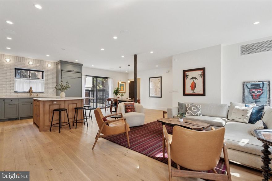 Nestled on one of Philadelphia’s most picturesque tree-lined streets, 1725 Addison is a fully renovated and thoughtfully combined double rowhome designed for modern living. Spanning 3,600 sq. ft., this stunning home offers oversized bedrooms, luxurious finishes, and abundant natural light. Featuring 4 bedrooms, a bonus den/office, 3 full and 2 half bathrooms, a finished basement, and rare 2-car parking plus 8 years remaining on a 10-year tax abatement. The first floor boasts an open-concept layout with a stunning foyer featuring honed marble checkerboard flooring and built-in storage. The living room includes a gas fireplace, recessed TV, and a custom bar with a beverage fridge and ice maker. The chef’s kitchen is outfitted with a Subzero refrigerator, black AGA gas range, custom inset cabinetry, and a large island with seating for four. The dining area opens to a private patio, and a rear entryway offers additional storage, a powder room, and access to two-car parking with an E/V charging station.The second-floor primary suite includes a spacious bedroom, a walk-in closet with custom built-ins, and a spa-like ensuite bath with a soaking tub, body-jet shower, custom double vanity and marble floors. A bonus room, ideal as an office or home gym, features a Juliette balcony. A laundry room completes this level. The third floor features three spacious bedrooms with soaring vaulted ceilings. Two of the bedrooms share a well-appointed bathroom with double sinks and a generous walk-in shower, while the third bedroom enjoys the privacy of its own en-suite bath. A convenient linen closet is located in the hallway for additional storage. The finished lower level offers 800 sq. ft. of versatile living space with 7.5’ ceilings. An expansive 8-foot-wide egress window floods the area with natural light, creating an inviting atmosphere. This level also includes multiple storage closets, utility space, and a convenient half bath. This meticulously rebuilt home features all-new windows, floors, joists, mechanicals, and finishes. Smart home upgrades include Sonos speakers, Nest thermostats, Ring security, Schlage keyless entry, and designer lighting. Live sawn white oak floors, luxury ceiling fans, and custom window treatments add to the home’s elegance. A rare opportunity to own a turnkey home on a coveted block in the heart of the city. Steps from Rittenhouse Square with the best dining and shopping in the city.