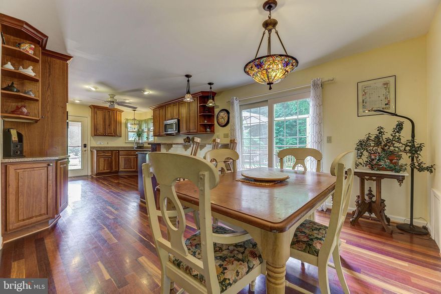 Make your move now to buy and enjoy INSTANT EQUITY with your real estate investment! This stunning 5-bedroom, 3-bathroom home, set on over 5 acres, offers the tranquil escape you've been seeking. With convenient access to Washington, D.C., Baltimore, Annapolis, and all of Southern Maryland, this property presents endless opportunities. While it is close to shopping and schools, it provides a serene environment that feels like a retreat from the hustle and bustle of everyday life. Experience the main-level owner's suite, which features double closets, a cozy sitting area, and an exquisite ensuite bathroom complete with a freestanding soaking tub and a step-in shower—a true sanctuary. The kitchen boasts cherry cabinets, granite countertops, Jenn-Air appliances, a pantry, and a breakfast bar, offering abundant counter space and storage. Additionally, the butler's pantry is equipped with a wet bar, a mini fridge, 15-pane pocket doors, and a dedicated office space. The front office, accessible through elegant French doors, adds to the home's functionality. The living room seamlessly flows into the formal dining area, creating a versatile open floor plan. The home showcases upgraded flooring throughout, including cherry, tigerwood, cork, and tile. The adaptable basement can serve as an in-law suite or an ideal recreational space, featuring a spacious fifth bedroom that functions as a second owner's suite with double French doors, a full bath adorned with impressive stone and tile work, and a beautiful walk-in shower. You’ll find the second kitchen complete with an oven, microwave, cabinetry, and a full sink, plus a refrigerator and a large freezer in the adjoining laundry room. There is even a workout area that currently doubles as a movie theatre area. The family room, enhanced by a large brick fireplace with a Regency wood stove insert and built-ins, is complemented by inviting cork floors and 2 sets of French doors. The expansive laundry room offers generous space, complete with a stainless steel commercial sink. A storage/utility room provides additional storage solutions. Outdoor living is made easy with a 24x16 cedar deck off the kitchen, featuring a custom sail cover. This deck extends to a covered outdoor area equipped with ceiling fans and outdoor curtains. The backyard is beautifully adorned with stacked stone walls, a 30x15 above-ground pool, firepit, and endless green grass. The lush landscaping, lovingly designed and maintained by a Master Gardener, showcases a diverse array of trees, shrubs, and flowers, ensuring year-round beauty. A 12x12 potting shed/greenhouse caters to gardening enthusiasts, while a spacious 32x14 shed/workshop with a barn door entry and deck is equipped with electricity, a workbench, and shelving for your creative projects. Additional outdoor features include a slate patio and walkway, fencing, and a gutter system. The recently repaved driveway is large enough to accommodate multiple vehicles, leading to a 24x21 oversized garage with attic space accessible via pull-down stairs for even more storage. New radon mitigation system too. Call for details today—this exceptional, meticulously cared-for property is a must-see!