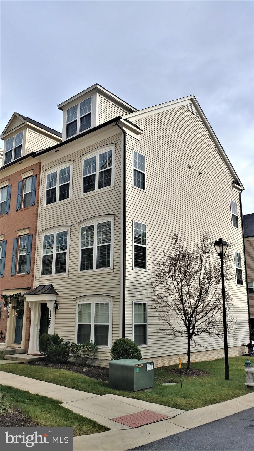 Beautiful, bright, 2013-built end unit townhome (largest model) w/upgrades & updates sure to please! 3 BR 2.5 BA, 4-level home in sought after Gallery Park! Stunning kitchen with gas cooking, granite countertops, huge 9.5' island, stainless steel appliances, tile backsplash and 42" cabinets. Main level crown moulding and upgraded custom lighting fixtures throughout. Balcony off the main level. Upstairs you'll find a custom ceramic tiled master bath and conveniently-located upstairs laundry. One car garage and carport/driveway parking. THE GARAGE IS CURRENTLY CONVERTED TO A LOWER LEVEL FAMILY ROOM/DEN WHICH CAN BE LEFT THAT WAY OR CONVERTED BACK TO A GARAGE AT THE BUYER'S REQUEST. This home is just footsteps away from beautiful courtyard/common area, and also very convenient to shopping (Clarksburg Outlets) and major routes (I-270 and Frederick Rd). Please remove shoes or use shoe covers while viewing the property. SELLER WILL PAY BUYER'S CONDO & HOA FEES THROUGH 12/31/19.