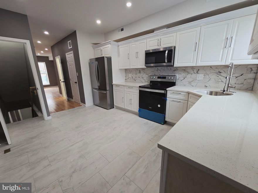 MOTIVATED SELLER, BRING US AN OFFER!!  Charming rowhome located in Northeast Baltimore, just minutes from Johns Hopkins  and Patterson Park! This beautifully updated home features a spacious brand-new white kitchen, brand new main level powder room, updated bathrooms, fresh paint, and new flooring . Finished basement is perfect for a home gym, play room, or theater!  Plenty of additional storage in the basement.  The fully fenced backyard offers excellent privacy—perfect for entertaining, make a backyard oasis, or can be used as a private parking pad. A fantastic opportunity at a great value. Schedule your showing today!