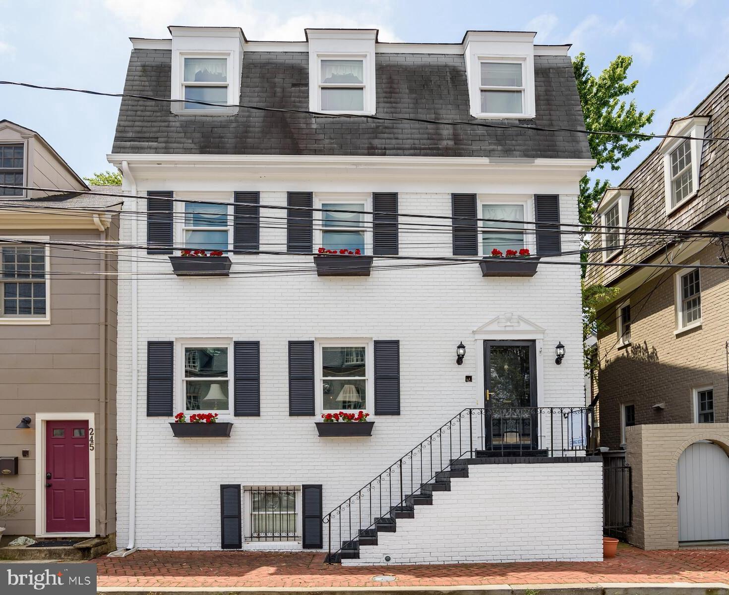 MAJOR PRICE ADJUSTMENT!!! This won't last! Amazing home ownership opportunity awaits you! Charm and an unparalleled blend of the city's historic and eclectic styles beckon you home to a brick row home showcasing over 3,500 square feet. Situated across the Naval Academy, this rare gem is appointed with a parking pad fit for 2 cars, a fenced-in deck, a spacious interior with a wood burning fireplace, hardwood flooring, opulent bedrooms with en-suite baths, a private lower level boasting a kitchenette and laundry, and much more! As a resident, enjoy the beauty and convenience of Historic Downtown Annapolis and the Naval Yard. Eclectic boutiques and restaurants offering an endless array of shopping and dining are a short strolls away, while local parks including Truxton Park, Quiet Waters Park, Lafayette Waterfront Park, and Actons Cove Waterfront Park, await you for a variety of recreational activities. Come and explore Annapolis right from your own backyard! Make sure to check out the 3D tour and floorplans.