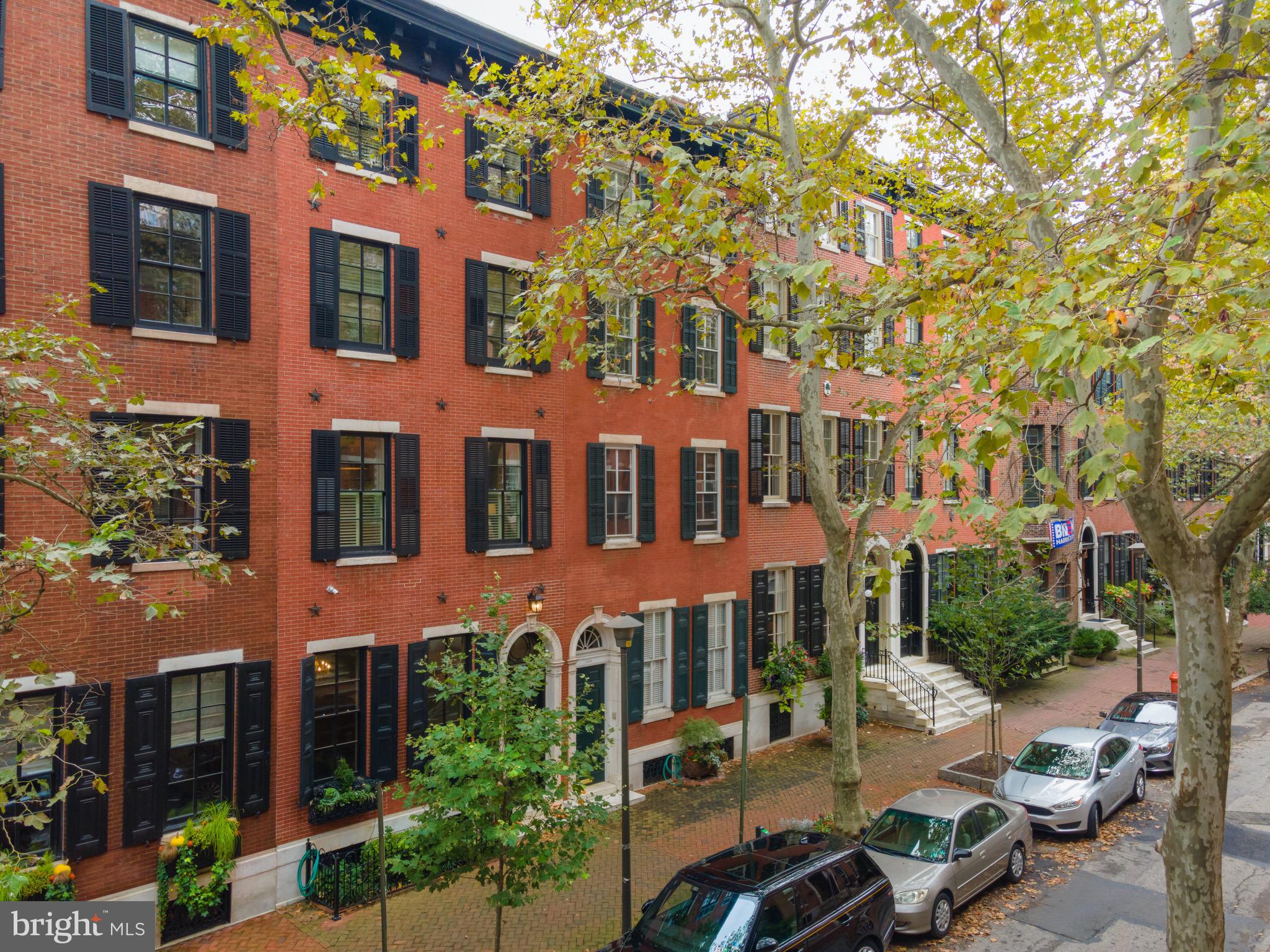Nestled on the most desirable block in Philadelphia, welcome home to 1816 Delancey, a magnificent, one-of-a-kind renovation. A true architectural oasis, this almost 4,700 square foot town home showcases the recent complete renovations with the highest quality luxury craftsmanship and design, while respectfully conserving its historical significance as home to Mary Curtis Bok, the founder of the Curtis Institute of Music. Stepping through the gracious vestibule entrance, the main level opens to a grand foyer with stunning marble accents and original details, including crown molding, period fireplace, marble mantles, and elegant archways. Enjoy signature, Delancey oversized windows form the entertaining room at front, fireplace, and a breathtaking, engraved ceiling. Continue through the main level to find a butler's kitchen, stately formal dining room, highlighted by stunning windows, brilliant tiling, window benches, and a period fireplace. Upstairs, the second level is the heart of the home, featuring a light filled, gourmet "Joanne Hudson" chef's kitchen with top-of-the-line appliances, gorgeous mill work and cabinetry, and breakfast nook. Enjoy grilling on the balcony! The spacious kitchen opens to a large formal dining room, which leads to a custom wet bar, powder room, and cozy living room. On the third level, find the Primary Suite, with an impressive walk-through dressing area, including two walk-in closets and multiple built-ins, a luxurious bathroom with double vanities, huge glass shower, and clawfoot soaking tub. The upper floors offer spacious bedrooms and completely renovated bathrooms, including access to the top floor balcony. The lower level finished basement is a versatile space for a large home gym, playroom, media room, or guest suite. This property includes 2 car tandem garage parking, along with a third parking option with an electric vehicle charging station in front of the home. Make your appointment now to view this remarkable, urban residence!