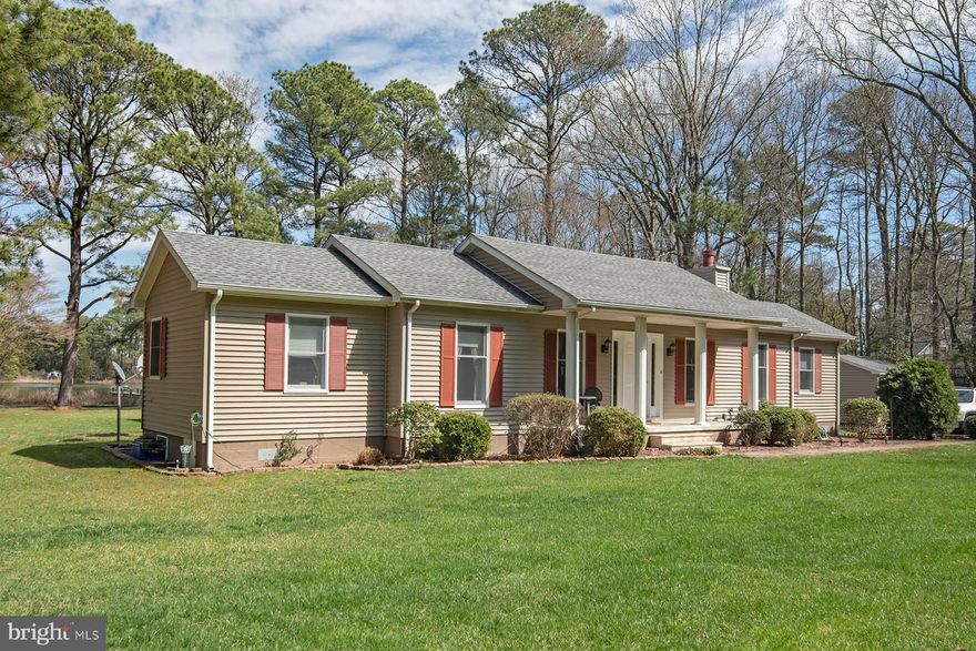 This charming waterfront home offers a peaceful retreat with stunning views of Irish Creek, nestled on 6+/- acres of private land featuring 200 ft. of shoreline.  A perfect blend of comfort and low-maintenance living, this one level home includes 2 bedrooms and 2 full baths, making it an ideal choice for those seeking waterfront living with easy upkeep.  The original home, built in 1995, was thoughtfully enlarged with a major addition in 1999, and two  wing additions were concluded in 2017, offering ample living space.  Inside you are greeted by the formal living  room with fireplace and wet bar, a cozy sunroom perfect for guest overflow, and a master bedroom suite, which includes a small office and walk-in closet.  Kitchen features new stainless steel appliances.  Step outside onto the large rear deck with retractable awning, ideal for entertaining or relaxing while enjoying the tranquility and warmer weather.  In addition to this outside living space, there is a waterside screened-in porch, located just off the kitchen.  The dock, which is 5 feet wide, with recently replaced planking, provides easy access to the water for your boating and recreational activities.  Whether you are looking to unwind or entertain, this home combines privacy, comfort, and effortless waterfront living in a truly serene setting.   

Fiber optic internet is available and the crawl space was recently encapsulated.