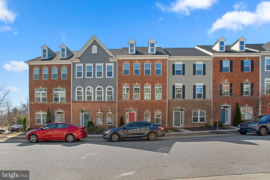 Stunning Colonial townhouse offering 3,062 square feet of beautifully designed living space, 4 bedrooms, 3 full baths, 1 half bath, and a 2-car garage impeccably maintained by the original owner in highly desired Shipleys Grant. The fully finished lower level welcomes you with a spacious foyer and a versatile mudroom area, perfect for a home office or additional living space, with direct access to the garage. Eclectic and elegant design choices define the open-concept main level, starting in the inviting living room featuring plush carpeting and a striking modern accent wall. A conveniently located powder room adds to the home’s functional layout. The gourmet eat-in kitchen is a chef’s dream, showcasing hardwood floors, quartz countertops, stainless steel appliances, ample rich cabinetry, an island with seating illuminated by stylish pendant lights, and a chic arabesque backsplash. The adjacent dining area exudes warmth and character with an accent wall and hardwood flooring.

On the upper level, you’ll find a laundry room, two full bathrooms, and three spacious bedrooms, including the bright and airy primary suite with a tray ceiling, a walk-in closet, and an ensuite featuring dual sinks. The uppermost level offers a private retreat, complete with a bedroom, attached full bath, walk-in closet, and access to a sprawling rooftop deck—ideal for relaxing or entertaining. Enjoy resort-style amenities in Shipleys Grant, including a community pool and clubhouse.