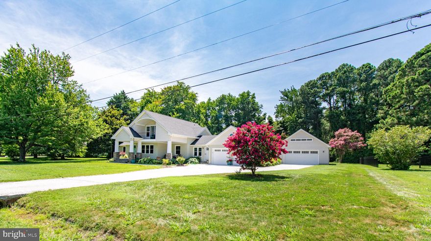 Experience luxury living in this newly renovated coastal-style home in St. Michaels. Situated on a double lot, this is an exceptional and rare offering, combining water views and water access with a high quality home, redone with incredible attention to detail and livability.  The exterior is tastefully appointed with painted brick and shingle-style siding, and an inviting covered front porch with blue stone decking, offering sights of the log canoe races on the Miles River.
The first floor boasts an open floorplan with elegant hardwood flooring throughout. The living room, adorned with a cozy gas fireplace, seamlessly flows into the dining area and kitchen, making it perfect for entertaining. The kitchen is any chef’s dream. The focal point is the leathered marble waterfall edge island with a dining bar, illuminated by two pendulum lights, offering ample space for meal preparation. A 6-burner gas range with double ovens, pot filler faucet and exhaust hood, French door refrigerator and generously sized undermount deep sink, all in stainless steel, and light-colored cabinets complete the kitchen’s inviting look. Accessed directly from the kitchen is a large, screened porch with brick flooring, overlooking the garden, for entertainment outdoors.
This floor also features three delightful bedrooms, one of which includes a sitting room and an attached half bath. An additional half bath, a full bath, and a dedicated laundry room equipped with built-in cabinets above the front-loading washer and dryer, and a partial basement offer enhanced convenience and functionality. 
The second floor is an exclusive owner’s retreat, featuring a spacious walk-in shower, a walk-in closet with custom-built ins, and a private balcony with breathtaking water views. The vaulted ceilings add an airy touch to the sanctuary. A large, climate-controlled storage room ensures that all your belongings have a place.
The property includes an attached oversized two-car garage and a detached oversized two-car garage with walk-up second-floor storage. The fenced backyard, which backs to lush trees, offers privacy and a tranquil escape. 
As a homeowner in the Rio Vista Community, you have access to the community dock on Spencer Creek with leasable boat slips, and an exclusive waterfront picnic area overlooking the Miles River. There are no town taxes.