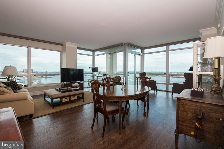 There is something special about the river views from this corner 2-bed, 2.5-bath condo at Waterfront Squares Regatta building. Immediately upon entering the unit, the sweeping northeastern orientation and extra-wide Petty Island divide bring the river directly into your living room and provide an indoor/outdoor connection that is truly unique. Additionally, you will cherish the eastern and southern vistas from your balcony or living room of the Ben Franklin Bridge and the seasonal fireworks. Enter this 1,489 SF unit past the convenient coat closet and powder room to the extra-large kitchen with stainless appliances, tons of cabinet space, granite counters & a large peninsula with extra cabinets. A laundry closet and pantry for extra storage is located just off the kitchen. The living room and dining room are the stars of this unit with floor to ceiling windows, new hardwood flooring, crown molding and stunning views of the river from every angle. Numerous options exist to configure a separate living and dining area, sitting area or office. A sliding door leads to the large patio ideal for that morning cup of coffee or evening glass of wine. There are 2 large bedrooms each with in-suite bathrooms and tons of closet space. Amenities abound in this gated complex with secure entry. 1-car valet parking, 24-hour concierge, fitness center, indoor heated pool, sun deck & shuttle service to Center City. Easy access to 95, Delaware Ave. and dozens of restaurants, cafes & bars in nearby Northern Liberties and Fishtown. Pet friendly community and owner is open to pets with some restrictions.  Waterfront Square in general has great views of the river but there is something special about this specific unit. The orientation and floor level make for infinity views of the river that are not replicated in other units. Pictures do not do it justice and you should see it in person. Will not last, schedule your showing today!