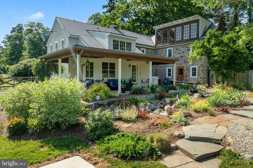 There is still time to move into this 1720 Farmhouse before the holidays!  Imagine spending your holiday season in this magnificent home which offers a captivating blend of historical charm and modern luxury set on approximately 15 acres of picturesque fields and woods.  Currently offering a $20,000 sellers assist!  Embrace the tranquility of nature from multiple outdoor sanctuaries – whether it's the wrap-around covered porch, European-style courtyard featuring a soothing babbling water feature pond, or the inviting heated 50x25 saltwater pool, all surrounded by lush gardens. Recent upgrades such as the DaVinci faux slate 2-year-old roof with a 50-year warranty and new windows ensure energy efficiency and peace of mind.
Inside the 4,944 square feet of artfully curated space, every corner exudes a warm ambiance enriched by original stone walls, exposed beams, and thoughtful design touches. The heart of the home is the open-concept gourmet country kitchen boasting custom cherry cabinets, soapstone countertops and sink, Wolf commercial range, Sub-Zero refrigerator, and Asko dishwasher, and a heated tile floor. It seamlessly flows into the breakfast room with its vaulted ceiling and loft, ideal for gathering with family and friends.
Relax in the living room adorned with an industrial glass door, a walk-in fireplace with a Jotul stove, and a floor crafted from 19th-century Philadelphia Roofing Co terracotta tiles. The family room captivates with its Hearth Stone fireplace insert, artisan sills, stained glass panel, and pine floors showcasing a rich patina.
Discover a serene library with black walnut floors and an elevated stone fireplace, originally a pub room in colonial times. Upstairs, three bedrooms and a laundry room await, with two bedrooms in the original section featuring fireplaces and rich wood floors. The second-floor bathroom invites relaxation with radiant floor heat, a glass shower, garden tub, artisan mirror, cherry counter,  and double sinks. Additionally, two bonus spaces offer flexibility as an additional office, playroom, or hobby room.
Ascend to the loft-like main bedroom sanctuary on the third floor, featuring wide-plank pine floors, custom ironwork, and three sets of French doors opening to views of towering trees, the pool, and a neighboring lake. Its boutique-style closet area includes a sitting area and open dressing/storage space. The uniquely designed bathroom boasts a stone and industrial glass shower, offering a serene bathing experience amidst treetops.
The finished lower level provides two additional rooms that could serve as a man-cave, home office, playroom, or exercise room. Outside, ample south-facing open fields present an opportunity for solar panel installation. A 6-car detached garage, with two bays currently used as a gym but easily convertible back, offers plenty of space for vehicles and workshop needs.
Recent upgrades ensure comfort and reliability, fence, widened driveway, including a multi-zone propane boiler, whole-house generator, well pressure tank, water filtration system, basement waterproofing, and an exterior French drain. The 2017 low-mound septic system further enhances the home's modern conveniences. Conveniently located just 2 hours from NYC, 60 minutes from Philadelphia, and 30 minutes from the Lehigh Valley, this home beckons with its blend of historical grandeur, artistic elegance, and modern comforts. Whether for a weekend retreat or a lifetime sanctuary, this farmhouse offers a rare opportunity to live amidst history and luxury.