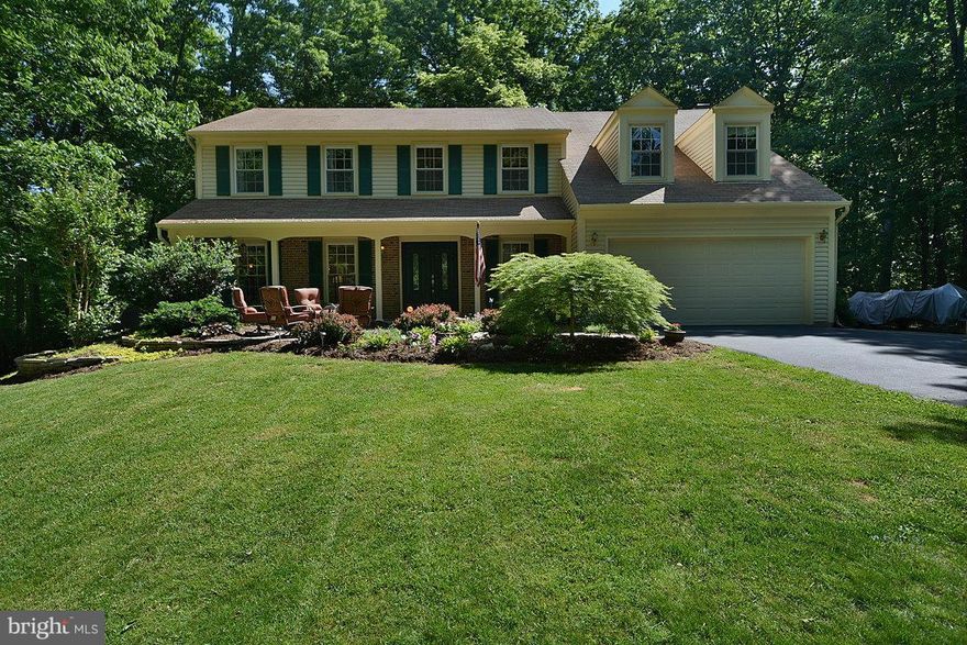 If you really look through the trees you will see a glimpse of this awesome colonial! It has been updated and upgraded. We have a totally new master bath, new windows, new granite counter tops, wood floors, newer heat pump and water tanks, new patios front and back, new carpet,   we have painted the whole house, and our pool is only 4 years old!  There is nothing left to do but move in!