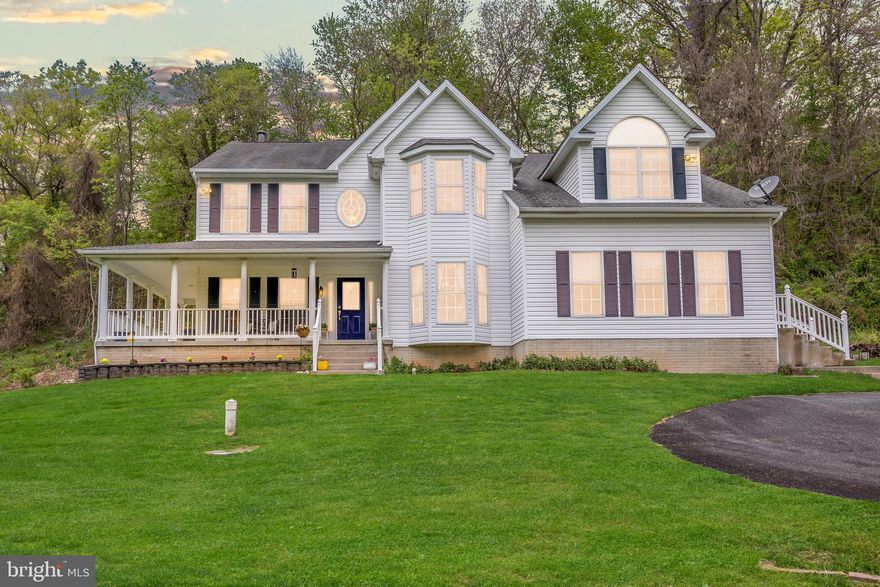 Situated on five private acres, this unique property offers a blend of significant interior scale and outdoor versatility. The grounds include a private pond complete with ducks, and ample space for those interested in gardening, chickens, or homesteading projects. With over 5,300 square feet of living space above grade, the main residence features an open floor plan designed for both comfort and practicality. The main level includes an extra-large kitchen, sitting room, dining room, and a dedicated home office, complemented by two distinct living areas: a bright, sun-drenched room at the front of the home and a central family room anchored by a dramatic two-story stone fireplace.
The upper level is home to four bedrooms and two full bathrooms, highlighted by a notably large primary suite. This retreat features vaulted ceilings, a private sitting area, a walk-in closet, and a spacious ensuite bathroom. Additional living space is found in the finished lower level, which provides a recreation room, another full bath, and three separate storage areas.
Beyond the main home and the detached two-car garage, a separate exterior building houses a shop and apartment space. While these areas require some renovation, it offers excellent potential for rental income, a guest house, a workshop, or a professional home-based business. This property is ideal for a buyer seeking a private, expansive setting with the flexibility to support a variety of lifestyle and professional needs.