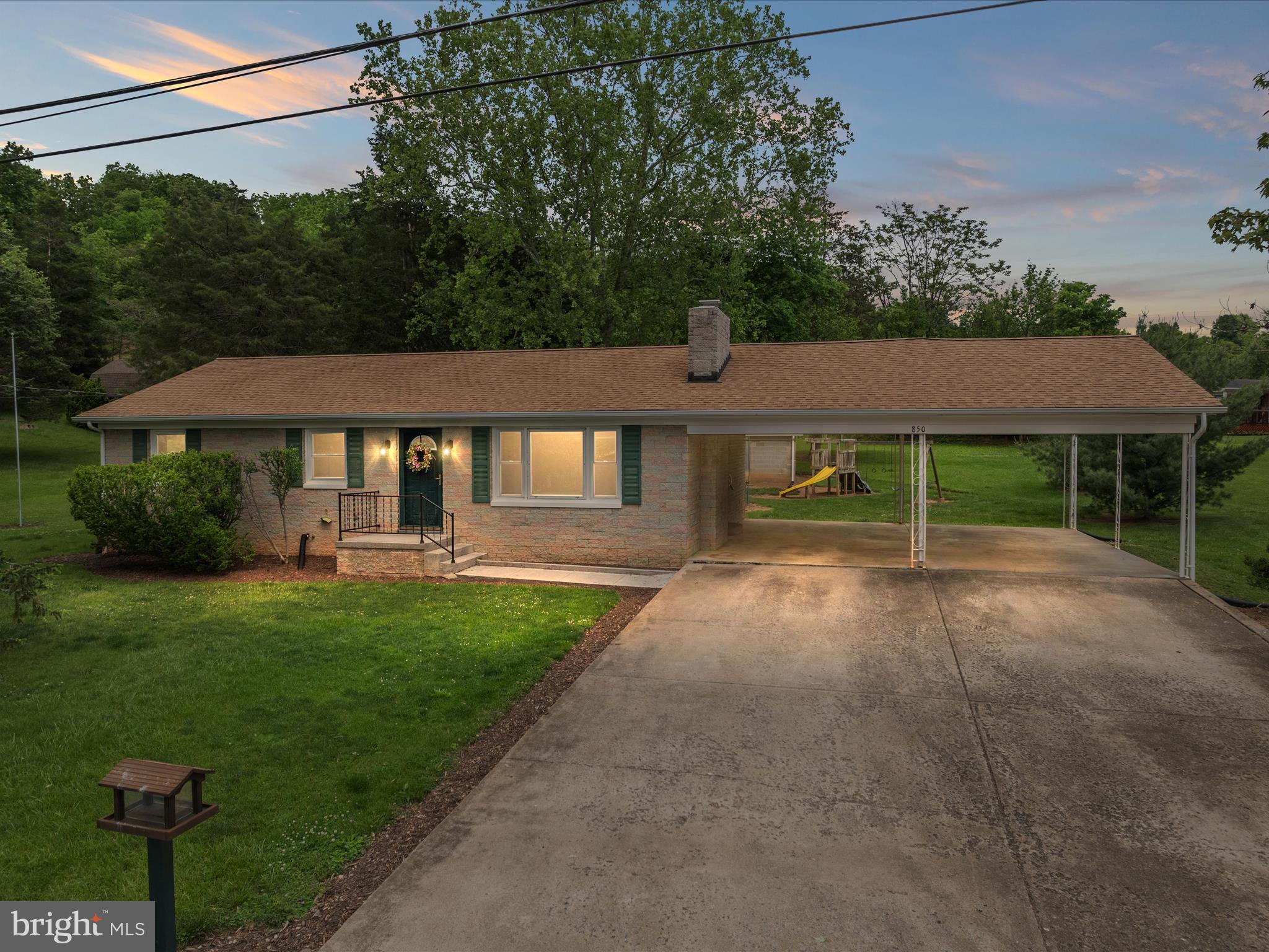 NEW UPDATES INSIDE AND MOVE-IN READY! Cozy rancher on a spacious 0.64-acre lot, featuring 3 bedrooms and 1 bathroom. Enjoy the convenience of one-level living with a full, unfinished basement offering a wood burning fireplace and endless potential for storage or future expansion. The basement also has a rough-in for an additional bathroom to be easily added. The kitchen boasts stainless steel appliances, a tile backsplash, wall oven, cooktop, and refrigerator—all less than 3 years old, along with the roof, gutters, heat pump, and water heater. Radiant ceiling heat provides a reliable backup heating option. The dining room features hardwood flooring, chair rail, and direct access to the backyard. The living room includes a cozy brick wood-burning fireplace with mantel, and beautiful hardwood flooring . Outside, you’ll find a double carport, a shed with a dog kennel and fenced area, and a fun playset in the backyard for kids. Call to setup your showing today!