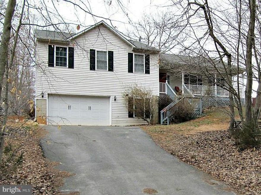 Tri level home in water oriented community. On almost 1/2 acre, corner lot. Spacious covered front porch, perfect for relaxing and taking in lake view.  Rear deck off of eat in kitchen. Large master suite with walk in closet. Nice sized living room and formal dining room. Huge lower level family room with 9ft ceilings, half-bathroom, and laundry.