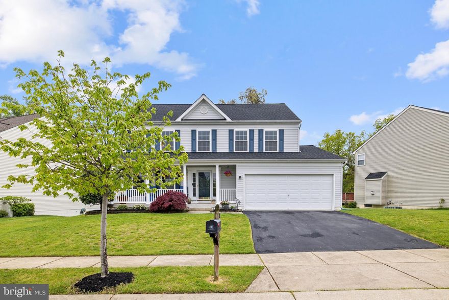 Lovely colonial residence with 5 bedrooms, 3.5 bathrooms, and a 2-car garage on a .15 acre lot that backs to trees.  Gorgeous curb appeal and a large front porch lead you into this meticulously maintained home, which has been freshly painted with crisp neutral colors throughout.   The main level features a formal living room and dining room with archways, crown moldings, chair rails, bay window, and wainscotting. Solid oak wood flooring spans the entire main and upper levels.  The gourmet eat-in kitchen is perfect for entertaining and offers a large granite island, granite countertops, stainless steel appliances and access to the deck.  The spacious family room overlooks the kitchen and is complemented with a fireplace.  The upper level provides a large master suite with walk-in closet and en-suite bathroom with large soaking tub, separate shower, and double vanity.  Three additional well sized bedrooms along with a laundry room complete the upper level.  The fully finished sun filled lower level awaits your personal touches with a bedroom, full bathroom, recess lights, ample storage space, and sliding glass doors to walk out to the back yard.  Unwind on the composite deck in style with a 4 point shade sail that keeps you cool as you enjoy your outdoor oasis.  This beautiful colonial residence is illuminated with natural light throughout and has easy access to commuter routes, shopping, and grocery stores.