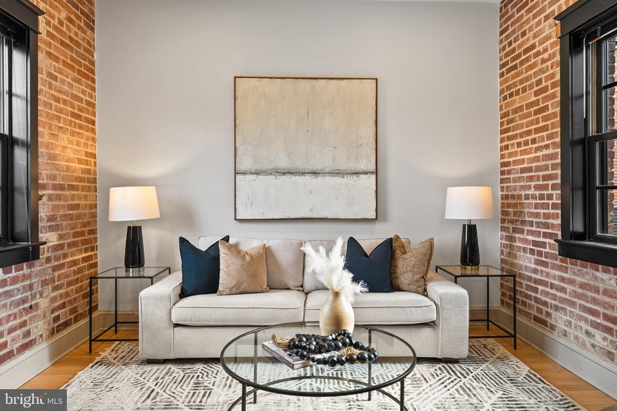 Welcome to the Quarters at Liberty, a collection of six new 1-2 bedroom, two-level condominiums developed by The Alexander Company inside the historic residences of the former prison guards. With an industrial loft aesthetic, this spacious 2,080 SF home welcomes visitors into an open floor plan with a living room, dining area, and kitchen.  The generously proportioned kitchen offers a breakfast bar, gas range, stainless steel appliances, granite countertops, and plentiful storage.  Just off the kitchen, the bright family room is appointed with exposed brick walls. A powder room and coat closet complete the main level.  Just upstairs are a home office area, primary suite with a large walk-in closet, en-suite bathroom and laundry, and a second bedroom with walk-in closet and bathroom. Residents of the Quarters enjoy all the amenities of Liberty including the fitness room, yoga room, community center, outdoor pool, playground, and Liberty Green.  Residents of Liberty enjoy shopping at Lidl, dining at Taco Rock, Yafa Grille, Ledo Pizza, and Kokee Tea, as well as working out at F45 or Capital MMA.   Parents appreciate the convenience of the renown Brynmar Early Education and Preschool right there at Liberty.  The Quarters is conveniently located less than 1.5 miles from I-95, 5 miles from Occoquan, 9 miles from Fort Belvoir, 17 miles from the Pentagon, 20 miles from Reagan National Airport and Washington, DC.