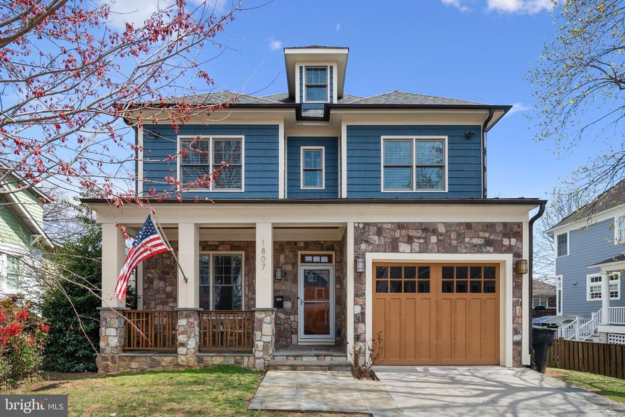 **HOT NEW PRICE on this stunning luxury Craftsman home in coveted Cherrydale!**  This gorgeously appointed 2012 built home has been newly refreshed inside and out, offering the perfect combination of PRIME location and gracious modern family living - mere minutes from all North Arlington has to offer! With 6 bedrooms, 6.5 baths, 4 levels, and thoughtful upgrades throughout, the whole family is sure to find comfort and privacy. Tastefully designed for everyday living, the heart of this home is an open concept LUXURY kitchen, featuring premium stainless steel appliances (Viking, Bosch), dazzling quartz countertops, custom wood cabinetry, stylish pendant lighting, and high-end backsplash. Sip your morning coffee at the long breakfast bar, or share a meal in the full size breakfast room located just off the kitchen. From there, you'll flow naturally into an immense family room boasting a gorgeous coffered ceiling, recessed lighting, and cozy gas fireplace. Rounding out the main level layout is a separate living room & oversized dining room (plenty of space to host fabulous dinner parties or family holidays!) - each with craftsman-style wainscoting detail, as well as a powder room, and thoughtfully placed mudroom next to your interior-entry garage. Complete with 10 ft ceilings, deep crown molding, recessed & statement lighting, and gleaming hardwood flooring throughout, the main level is sure to impress! Upstairs, thrill to the expansive owner’s suite with not one but TWO walk-in closets offering premium custom closet organization, as well as a LUXE spa-like en-suite bathroom featuring dual full-size custom vanities (w/ medicine cabinets & storage), a jetted tub, separate glass-walled shower w/ stone pebble floor, and a private water closet. Also on this level are three more generously sized bedrooms, each with its own en-suite bathroom & abundant closet space (walk-in or dual closets), as well as a roomy landing w/ built-in bookcase & convenient bedroom-level laundry room. Continue up one more level to find a bonus flexible loft space, perfect for a play or recreation room! This level also includes a fifth bedroom with access to its own full bathroom - guest retreat or private office suite? You choose! Back downstairs, enter the basement to find the very best in multi-generational living, au pair accommodations, or just more fantastic entertaining space! The huge rec room has been completed with a fully outfitted kitchen featuring a full-sized range, fridge, dishwasher, oversized quartz island, and plenty of storage space. Your guests won’t be complaining of cramped quarters, because they have their very own roomy living/dining space w/ cozy gas-powered fireplace, as well as a large separate bedroom w/ walk-in closet, huge den/bonus room, full bathroom, and bonus walk-in closet for even more storage! The basement also features its own convenient exterior access to the back yard. Outside, your fully fenced backyard includes a gracious slate patio - the perfect place to hang out and relax or enjoy al fresco dining with friends and family! Enjoy the numerous premium touches and upgrades throughout this special home, including high ceilings (10 ft main level, 9 ft upper level), deluxe crown molding, coffered ceilings, wainscotting, hardwood flooring, built-ins, premium window treatments & plantation shutters, new carpeting (2025), fresh designer paint throughout (2025), fresh exterior paint & stain (2025) and much more! The Cherrydale location is truly unparalleled! This idyllic, tree-lined street is just a quick walk from neighborhood favorites like Arrowine & Cheese, Pastries by Randolph, Cafe Colline, Child's Play & more! Enjoy easy commuting with nearby bus and metro routes (less than 1 mile from Ballston metro!) and convenient access to I-66, as well as all the North Arlington favorites - shopping, dining, parks, Ballston - even the Cherrydale Farmer’s Market! You'll love calling 1807 N Stafford Street HOME!