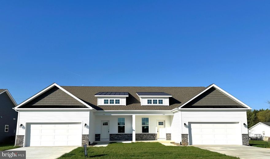 Discover exceptional style and comfort in this 4-bedroom, 3-bath home offering 2,084 sq. ft. of thoughtfully designed living space in one of Berkeley County’s most desirable new neighborhoods.
A dramatic two-story living room sets an impressive tone from the moment you step inside — filled with natural light and designed as the centerpiece of the home. The open layout connects seamlessly to the dining area and a beautifully appointed kitchen featuring granite countertops, stainless steel appliances, a center island with seating, and a corner pantry for everyday convenience. Luxury vinyl plank flooring flows through the main living areas, bringing durability and style together.
The main-level primary suite offers a private retreat with dual walk-in closets, a tiled shower with built in bench seat with glass door, separate soaking tub, and a sophisticated barn door into the en-suite bath. A second bedroom on the main level provides flexibility for guests or can serve as a comfortable home office or study.  Nearby main-level laundry keeps daily routines simple and efficient.
Upstairs, an open loft overlooks the living room below. Two additional bedrooms and a full bath ensure everyone has a place of their own.
Step outside to a covered rear screened in porch — ideal for relaxing outdoors, enjoying morning coffee, or entertaining friends. Attractive stone water table accents enhance the exterior and reflect the craftsmanship seen throughout the home. A 2-car garage adds parking and storage convenience.
Located close to shopping, dining, schools, and commuter routes, this home delivers the perfect blend of space, style, and modern living — in a community you’ll love to call home.  60 Day delivery, Stop by our Model home on Barrier Reef Drive to take a tour!