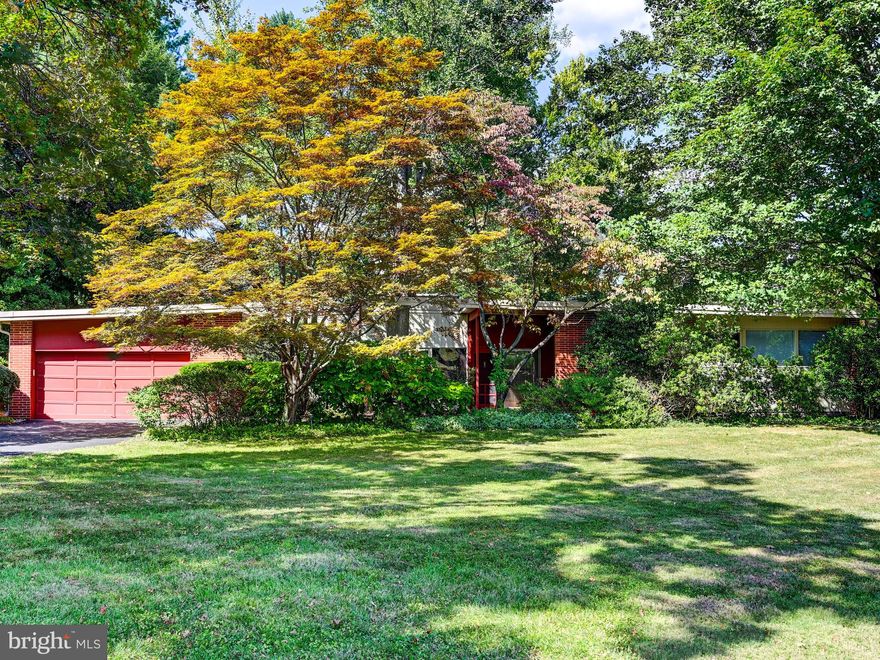 Enjoy easy living in this striking sprawling mid-century modern home with 2 car attached garage on one of the largest corner lots (.97 acres) in the neighborhood. The sun drenched living room & dining room has expansive walls of glass, high beamed ceilings & a brick floor to ceiling fireplace. The eat-in kitchen offers abundant cabinetry, double wall ovens & a convenient main level laundry room. The spacious primary suite features multiple closets & an updated bath with tiled shower. Two additional bedrooms & another full bath complete this level. The bright walkout lower level has lots of windows & includes a large family room with door to rear yard, 4th bedroom currently used as an office & another full bath. A large storage shed provides space for extra storage. The serene parklike rear yard is a wow! There is also an irrigation system & fountain, 3 zones heat & AC replaced 2025. Don't miss this one!