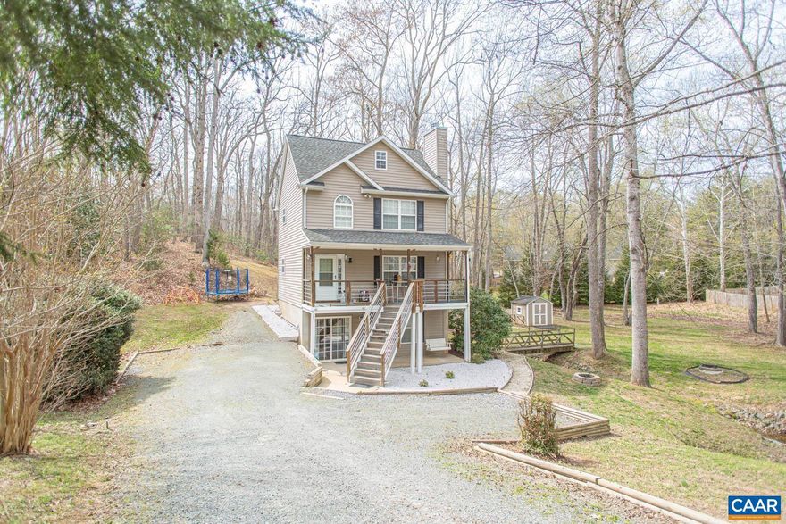Relax & unwind in this charming Lake Monticello home! From the moment you arrive, you?ll be impressed with all this property has to offer from the park-like setting to the stylish details throughout. A large, covered front porch welcomes you into a bright entry with custom detailed staircase. The main level features hardwood floors throughout, a cozy living room with woodburning fireplace, & eat-in kitchen with newer appliances & painted cabinets. Upstairs, you?ll find two primary suites, each with an ensuite bath & features such as dual sinks & updated fixtures. Don?t miss the walk up, unfinished attic space- perfect for storage or customizing to fit your needs. The basement provides extra space for a home office, playroom, or fitness, with an additional bedroom & full bath and the laundry/utility room. Outdoors, enjoy the half acre lot nestled into a park-like setting with a picturesque bridge & peaceful creek. Outdoor living abounds with multiple areas to relax & entertain. Enjoy the many amenities the Lake has to offer including beaches, tennis & basketball courts, sports fields, playgrounds. & pool. Conveniently located near the Food Lion gate. 2 miles to Beach 2 & 25 mins to downtown Charlottesville & UVA Med Center!,Painted Cabinets,Wood Counter,Fireplace in Living Room