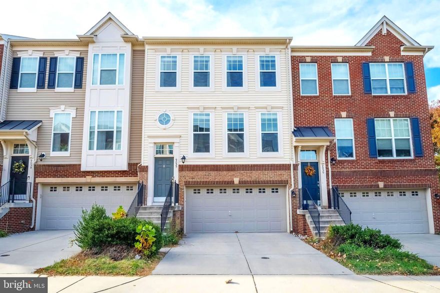 This stunning 3-level, 2,288 sq ft townhouse combines luxury and convenience in a perfect location. This home offers a light-filled, open floor plan with a welcoming foyer, three bedrooms, and 2.5 baths. The main level includes a spacious kitchen, dining, and living area, all with large windows. The gourmet kitchen features custom 42" maple cabinets, a 10-foot granite island, tile backsplash, and stainless steel appliances, with a large composite deck off the kitchen that overlooks trees—perfect for morning coffee. Upstairs, the primary bedroom includes a walk-in closet and an en-suite bath with dual sinks, a separate shower, and a soaking tub. Two additional bedrooms and another full bath complete this level, with beautiful new hardwoods on the stairs and upper hallway and a stylish crystal chandelier. The lower level has 12-foot ceilings and oversized windows, creating a bright, open feel. Step out to a private fenced patio with courtyard-style decor. Plenty of guest parking is available within the community, making it easy for visitors. Conveniently located close to everything including the VRE, major commuting routes, shopping, restaurants, golf course, and Signal Hill Water Park.