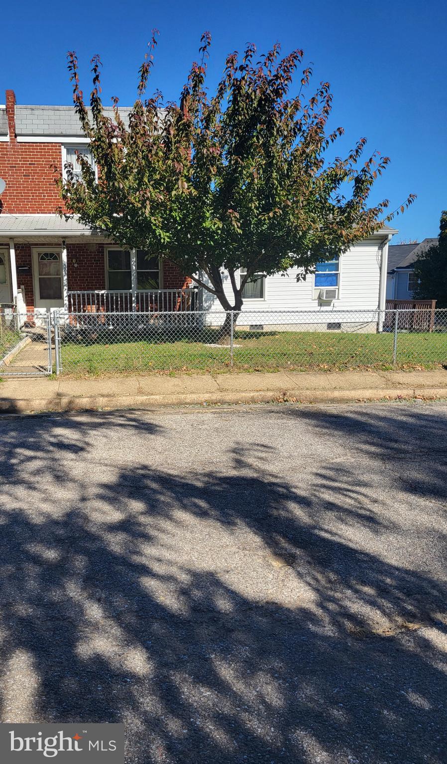 Back on the market! Many updates and repairs have been made to this 5- bedroom 2 bath end unit row home, with 2 units. The original floor plan boasts 3 bedrooms and 1 full bath on the upper level. Combination living/ dining room area on the main level. The updates include, Fresh paint, wall /ceiling repairs, New Kitchen cabinets with back splash, and new flooring in the kitchen and bathroom. You will be amazed at the before and after pictures! There are original hardwood floors throughout. Laundry is in the basement with access to your back yard! A deck with outside access on the side of the home, leads up to the second unit. This space has 2 bedrooms and 1 bathroom, with kitchen/dining combination. Perfect for extended family, guests or rental potential! There is a partial water view of the harbor! Large fenced in yard with front porch and plenty of on street parking. This home is waiting for some TLC and is being sold AS IS. It's priced to sell! Your lovely new home is waiting!