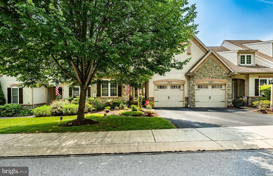 Welcome to The Woods at Rock Raymond, a highly sought-after 55+ community that is an entertainer's delight. This open floor plan offers 1,918 sq ft + a partially finished walk-out basement with windows and plumbing for a 4th bathroom.  The main level consists of an entry foyer, a formal dining room with tray ceiling, a gourmet kitchen that includes 42" cabinetry with pull-out drawers, granite counters, tile backsplash, pantry, stainless appliances, and gas cooking. Family room with a vaulted ceiling and gas fireplace, adjoining a Florida room that leads to an oversized entertainment deck facing south, complete with a retractable awning. The primary bedroom and bath are also conveniently located on the main level. A half bath and laundry finish the main level. The upper level offers a bonus family room, a full bath, and two bedrooms. The home features $ 30,000 in upgrades, including recessed lighting and extensive hardwood flooring added to the kitchen and living area. The deck has been doubled in size, the kitchen counters have been upgraded, and new appliances were installed in 2024, including a refrigerator, stove, and microwave. New upgraded windows in the sunroom. There is a one-car attached garage. The home has natural gas heat.