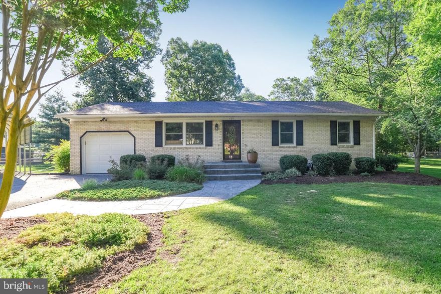 All Brick Rambler situated on large wooded lot that backs to trees!  Featuring 3 bedrooms, 2.5 baths, separate dining room, kitchen, large family room  and a 1-car attached garage, this home offers lots of space for everyone!  Renovated kitchen with 42" natural maple cabinets, granite counters, back splash, side by side refrigerator, smooth top stove, built-in microwave and counter bar space for extra seating.  Separate dining room with hardwood floors is great for special family meals.  Large step-down family room with a brick wood burning fireplace with gas logs, custom built-in book cases, exposed wood ceiling beams is the perfect place for family time!  Split-style master bedroom with his & her closets with organizers, bay window, ceiling fan and attached master bath.  Updated master bath with ceramic flooring. 2nd bedroom with great closet space.  3rd bedroom with an attached half bath.  Upgrades and special features include  hardwood floors throughout, an attached garage with auto opener, a detached garage with an extra door, covered carport, light fixture updates, window replacements (2019),  roof/gutters/shutters (2017), hot water heater (2016), HVAC/Heat Pump (2015), septic replacement (2008), fenced large back yard and nice shed.  One level living offering lots of privacy and space! This home is a must see!  (RELOCATION SALE - Altair Global Relocation)