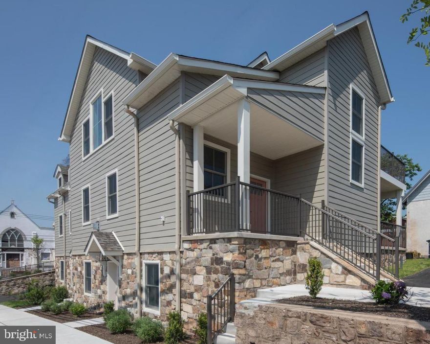 Just one block off Ambler’s iconic Butler Avenue, The Colony Club features two luxury new-construction homes. Originally built in 1912, this Ambler landmark has been completely transformed, preserving its timeless character while delivering the quality and sophistication of brand-new construction. Once home to a vibrant social club and later a library and community gathering place, the building has been thoughtfully re-imagined to honor its architectural roots while offering every modern amenity. The builder’s craftsmanship is evident from the start, beginning with the lifting of the original structure to install new foundations and a lower-level living space. All components were newly installed in 2024 and 2025.

Unit B welcomes you through a covered porch entryway into a bright foyer that opens to a spacious Great Room with solid oak engineered hardwood floors, tall windows, recessed lighting, custom built-ins, and a gas fireplace that adds warmth and character. The gourmet kitchen features shaker cabinetry, granite countertops, stainless-steel appliances, and a large island with farmhouse sink, opening to a private deck that’s perfect for morning coffee or entertaining guests. A half bath completes the main level. Upstairs, the primary suite offers a serene retreat with hardwood floors, an 11-foot tray ceiling, multiple walk-in closets, a cozy sitting area, and a spa-inspired bath with dual vanities and walk-in shower. Step out onto your private balcony and enjoy peaceful views above Ambler. The ground floor includes two additional bedrooms, a den or home office, a full bath with ceramic tile, and a laundry room all with the same attention to detail found throughout.  Every inch of this home has been rebuilt to modern standards from the individually zoned HVAC system to reinforced structural framing ensuring comfort, efficiency, and longevity. Three coveted off-street parking spaces add convenience, while the property’s location one block off Butler Avenue means dining, shopping, and the train are just steps away. The Colony Club offers something rare the soul of a historic building paired with the ease and sophistication of new construction. If you’ve been waiting for luxury living in the heart of Ambler, this is the one to see.