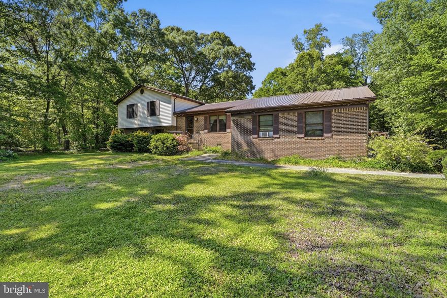 Wish you could find that private, living in the country with chickens on an acre of land vibes but where you can go for a run on paved roads past beautiful homes in the community? Welcome to Lakeland Dr!  The best of both worlds.  You can walk through the front door into the heart of the home - the dining room and kitchen coming to life with the sounds and smells of home. (Maybe you want to move dining back into the eat-in kitchen and add a main level living room.) Or you can slide through glass doors from the back deck. The 400 sq ft addition has a whole variety of uses, its own entrance, and a wood burning stove.  Once a recording studio, it makes a perfect spot for movie night, game day, rowdy play dates, or working from home behind glass. Inside the main home, you get a primary bedroom and bath plus two additional bedrooms and a hall bath to share upstairs. Downstairs, a den, additional separate rooms for storage, crafts, work or guests complete with laundry and a third full bath. Great for wet feet coming in from the hot tub too! Plenty of paved parking for gatherings with friends, and plenty of storage or room to work in the 24X24 ft detached garage. All in a prize location convenient for Chaptico Park, the library, amish markets and even a golf course.  Welcome Home!