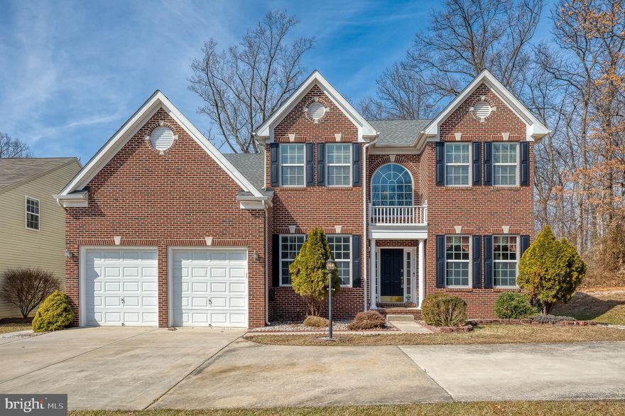 Welcome to this remarkable 6-bedroom, 3.5-bath Colonial residence located in the sought-after Cedar Lane Farms neighborhood. This home seamlessly blends comfort, style, and functionality. Situated in a tranquil community, this beautifully maintained property offers a thoughtfully designed layout, guiding you through each level with intentional flow and purpose. Gleaming hardwood floors and elegant crown molding set the stage for the main level’s open and airy design. To the right, a sun-drenched formal living room offers the perfect setting for quiet gatherings or a home library. Adjacent is the formal dining room, enhanced by wainscoting and a classic chair rail—ideal for hosting family dinners and holiday celebrations. At the heart of the home, the spacious kitchen features tile floors, recessed lighting, modern stainless-steel appliances, granite countertops, a large pantry, and abundant cabinetry. Enjoy the convenience of a built-in desk, a double wall oven, and an island with a breakfast bar overhang. An additional high-top breakfast bar extends from the breakfast nook side, offering even more seating. The bright breakfast nook, accented with crown molding and a ceiling fan, is bathed in natural light—creating a cozy space for morning coffee. The inviting family room, anchored by a charming fireplace, offers a warm retreat for relaxing evenings. Completing the main level is a private home office, a convenient half bath, and a laundry room with direct access to the attached garage. Upstairs, crown molding continues throughout the hallways, adding a touch of elegance. French doors open to the luxurious primary suite, a true sanctuary featuring a generous walk-in closet and a spa-inspired ensuite bath with a soaking tub, separate walk-in shower, and dual vanities. Four additional spacious bedrooms, each filled with natural light and ample closet space, provide flexibility for family, guests, or creative spaces. An updated full hall bath with modern fixtures completes this level. The partially finished walk-out basement is designed for ultimate versatility. It features a second full kitchen with granite countertops, stainless steel appliances, recessed lighting, a dedicated pantry, and a breakfast bar—ideal for multi-generational living or extended guest stays. The expansive recreation area, with tile floors, recessed lighting, and a charming brick fireplace, offers a cozy yet functional space for a media room, fitness area, or game nights. Two additional bedrooms and a full bath provide private retreats for guests or extended family. Direct access to the backyard makes outdoor activities a breeze. Step outside to a beautifully landscaped backyard, a true extension of the living space. The two-tier composite deck is perfect for outdoor dining and summer BBQs, while the lower-level patio offers a shaded spot for relaxing afternoons. A charming gazebo invites peaceful moments, and the spacious storage shed keeps tools and equipment neatly tucked away. With ample storage throughout, an attached garage, and a prime location near shopping centers and major commuter routes, this exceptional Colonial property in Cedar Lane Farms offers the ideal balance of convenience, luxury, and thoughtful design. Don’t miss the opportunity to call this stunning property your forever home!