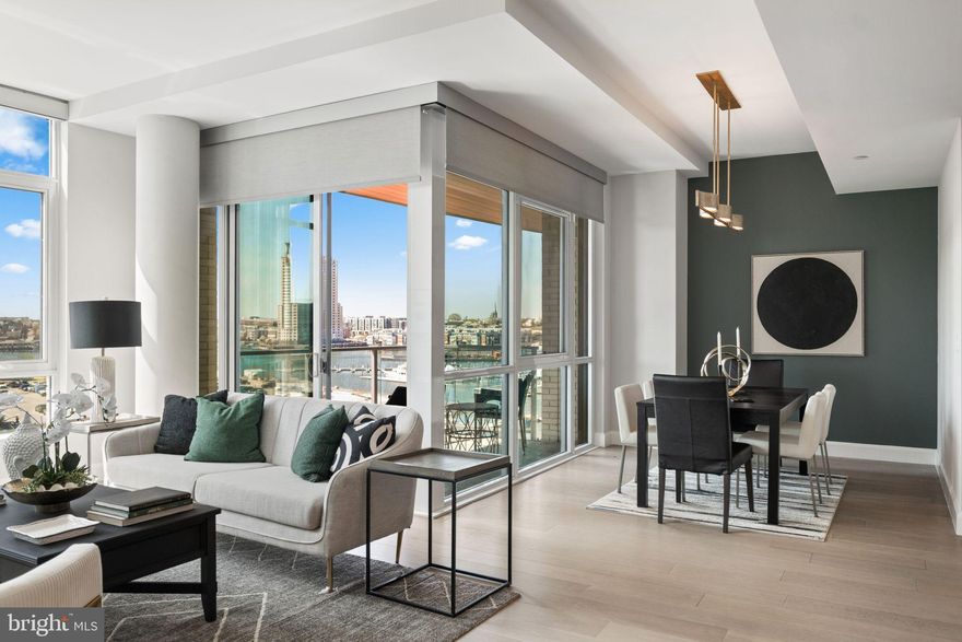 Experience luxury waterfront living at Liberty Harbor East! This stunning 2-bedroom, 2-bath residence offers over 1,500 square feet of sophisticated like-new space. With breathtaking panoramic views of the city and water, this is one of the few units in the Liberty to enjoy a private balcony off of the main living area. The unit is ideally situated in the building to maximize harbor views while providing a calm and quiet retreat in the heart of Harbor East. This smart home features soaring ceilings, oversized windows, wide plank oak floors, and a custom mirrored media wall with TV and gas fireplace. The spacious chef’s kitchen boasts Italkraft cabinetry, Thermador appliances, and a waterfall marble island- perfect for any home chef! The spacious primary suite offers floor-to-ceiling windows, a custom California Closet, and a spa-like en-suite bath with Carrara marble, Kallista & Kohler fixtures, and dual vanity. A split layout ensures privacy within the unit. The second bedroom is generously sized with a walk-in closet and an additional hall full bathroom. One garage space is included in the purchase. Residents enjoy unmatched amenities at the Liberty including a rooftop infinity pool, state of the art fitness center, pet park, concierge lounge, private dining, and direct access to Whole Foods. Steps from top dining, shopping, and waterfront paths—this is the ultimate downtown lifestyle.