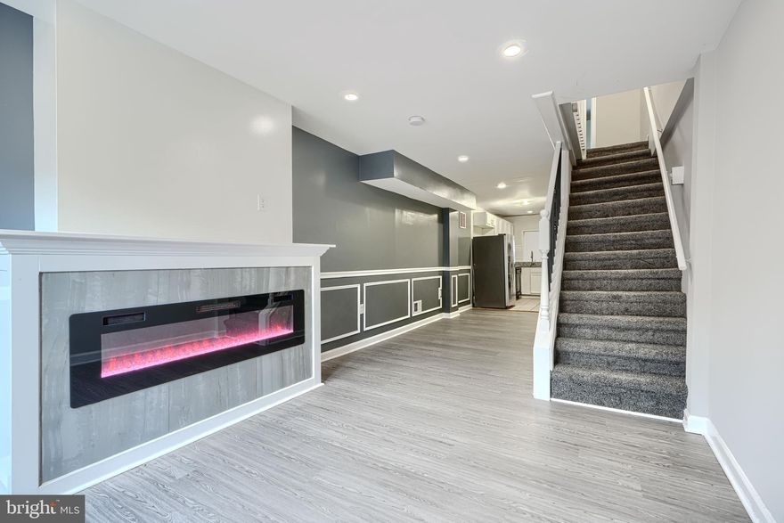 Welcome to 1127 Sargeant St, a s fully renovated 2-bedroom, 1.5-bath home nestled in the highly sought-after Washington Village community. This home perfectly blends modern luxury with timeless charm and is ideally located near all the best Baltimore has to offer! Step inside and be captivated by the custom craftsmanship throughout — featuring elegant wainscoting, luxury vinyl flooring, and recessed lighting that creates a bright, contemporary feel. The spacious living and dining area is anchored by an electric fireplace with custom lighting and flame effects — perfect for cozy evenings or entertaining guests. The gourmet kitchen boasts granite countertops, stainless steel appliances, and ample cabinet space for all your culinary needs. Downstairs, you’ll find a large partially finished basement with beautiful ceramic tile flooring — ideal for a recreation room, home office, or gym. Outside your door, you’re just minutes from I-95, shopping, restaurants, schools, and public transportation — plus walking distance to the Inner Harbor and Baltimore’s football and baseball stadiums. Don’t miss your chance to own this beautiful, move-in ready home in one of Baltimore’s most vibrant neighborhoods!